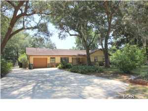 What a great house for a large family close to Tyndall AFB. This waterfront home has 3 spacious bedrooms - all with walk-in closets, 2 baths - the master has double sinks, 2 showers - yes 2 and the hall bath has access to the backyard/pool area, a separate office, a formal dining room & breakfast area, expansive kitchen with large walk-in pantry, open floor plan from kitchen to living room with fireplace, spacious laundry room, covered front & back patios, partially fenced in backyard with 36 ft in-ground pool, workshop that is 20 x 24 with insulated walls, floor to ceiling shelving on 2 sides and 100 amp power panel, another detached storage shed, a one-car oversized attached garage with workshop area, and a covered parking area that will accommodate a boat or other large item. The