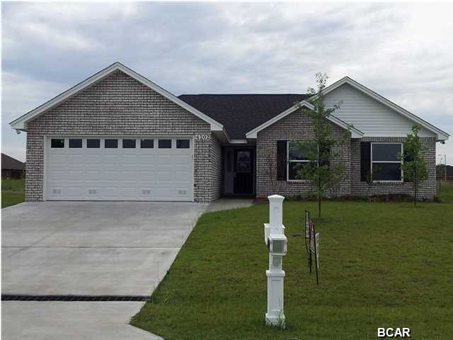 This Custom Built Home by locally renowned builder is 3 bedroom 2 bath all brick home that offers master bath with his & hers double shower with two heads and shower seats on both ends, and walk in closet. The kitchen is a dream with all wood cabinets, solid surface countertops, and stainless steel appliances. There are cabinets in the laundry room. Living room with and electric fire place and crown molding. Home even comes with a security system and generator ready electrical outlet with cord. Outdoors there is an enclosed screen patio and outside shower, and sprinkler system. Home is built to 130 MPH wind code. Located at Bylsma Manor Estates with many homes already built and waiting for you to tour today. Ask about No Money Down, No Closing Cost and No Pre-Paids. If