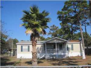 Priced to sell quick!! This is a nice 3br/2BA double wide mobile home located in Gulf Pines of Panama City Beach. This property is centrally located, close to the Navy Base, shopping, dining, beaches, schools, entertainment and so much more. It has a Sunroom, very large lot, and orange tree in the back yard. This is an affordable property to get-away, or great for a first time buyer or investor.