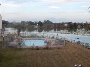 ENJOY BOTH A LAKE AND THE BEACH IN THIS GREAT LOCATION WHICH IS LAKE FRONT AND APPROX 1/2 BLOCK TO THE BEACH. LARGE MASTER BEDROOM WITH VIEW OF LAKE AND LIVING SPACE BOTH HAVE VIEW OF LAKE. SELLER OFFERING $1500 TOWARD NEW SLIDING DOORS IF NOT INSTALLED BY THE TIME YOU BUY IT. ALL FURNITURE, WASHER/DRYER AND APPLIANCES CONVEYED UPON SALE, BUT SHORT LIST OF STAGING ITEMS WILL NOT CONVEY. HVAC UNIT NEW 2014, REASONABLE FEES INCLUDE WATER, CABLE, SHUFFLEBOARD, DOCK, POOL, GROUNDS MAINTENANCE, PEST CONTROL, AND GARBAGE. RENTALS ALLOWED AND ON-SITE MANAGEMENT COMPANY. GOOD VALUE FOR LOCATION-COME AND SIT ON THE DECK AND LOOK AT THE LAKE WHILE YOU PONDER YOUR OFFER...*All information including measurements are approximate and should be verified by Buyer.