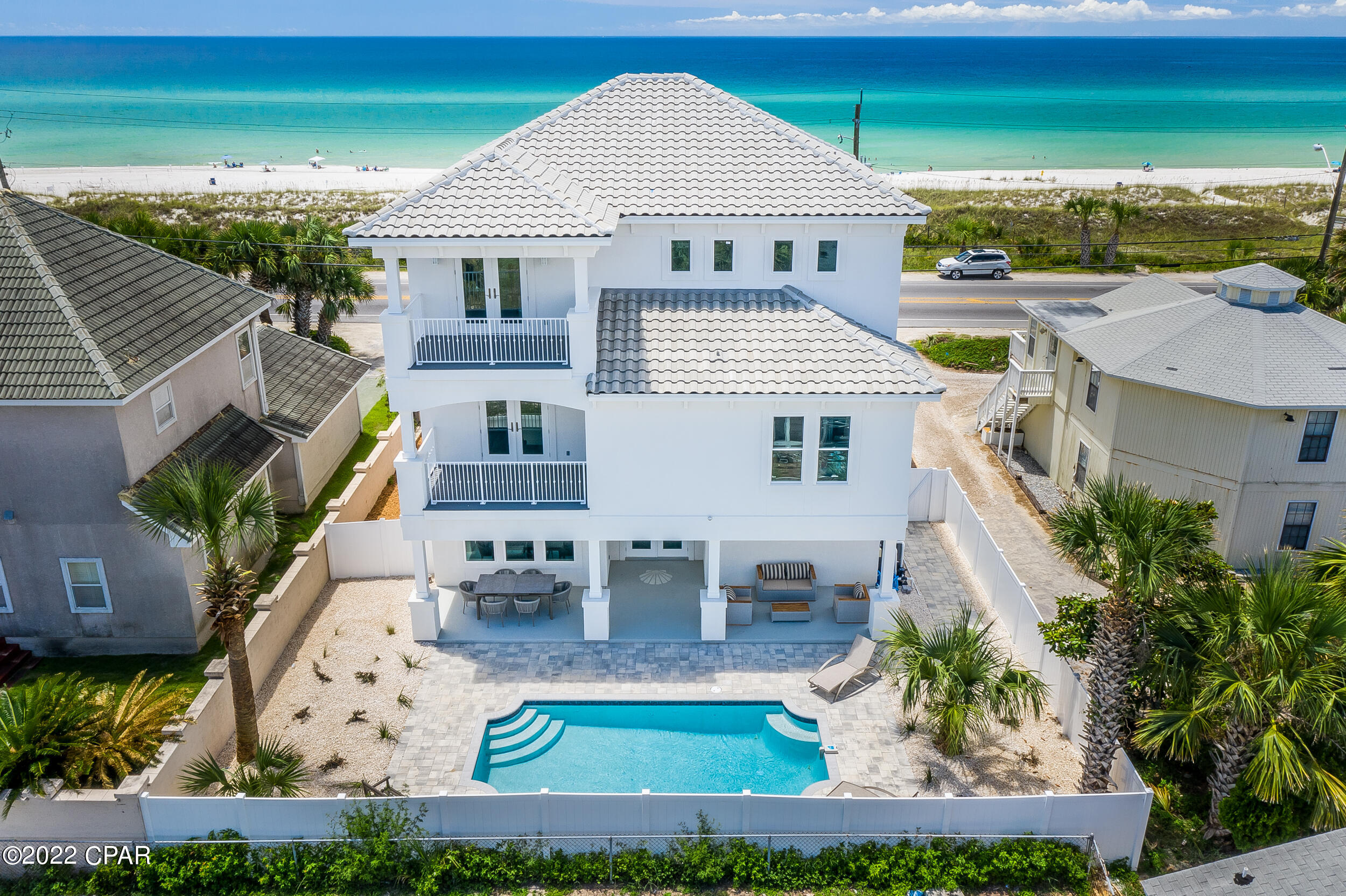 ** CURRENTLY UNDER CONTRACT, SELLER WILL CONSIDER BACKUP OFFERS** What makes a perfect beach house? Stunning views? Large balconies? A pool for when you want to step away from the beach? Plenty of room to entertain?



14208 Front Beach Road has all of this and more. Located in Bid-A-Wee Beach, the only gated beach in Panama City Beach, this home provides a comfortable and relaxing vacation get-away, but it's also the perfect place to entertain plenty of friends and family, or even turn into a vacation rental.



Upon entering, you'll find yourself on a landing between the first and second levels. Up the stairs to the right is the kitchen, living room and two bedrooms. Downstairs to the left is a newly built kitchenette and game room looking out over private pool. 



The kitchenette was recently upgraded just steps away from the pool, the kitchenette prevents residents and guests from having to climb two flights of stairs for a snack or a drink. It also helps keep those wet footprints from accumulating all over the house. Beside the kitchenette is a game room with an air hockey table, flat screen TV and sitting area. It's easy to enjoy a sporting event or a show in the air conditioning while being able to keep an eye on the pool. 


Upstairs on the second floor is the main kitchen and living room. A large island provides seating room for five stools and plenty of countertop space for laying out an expansive spread of food. The backsplash features an intricate design above the stovetop, adding a layer of beachy character to the home. The stainless steel refrigerator has one clear door, helping prevent the excessive amount of opening and closing when searching the fridge for a snack. 

The kitchen seamlessly opens to the living room which also has plenty of sitting room. Natural light floods in from the double doors to one of five gulf-facing balconies. Gorgeous vertical windows flank either side of the television and in-wall fireplace for those chilly winter days. 


On this level there are also two spacious bedrooms, each with its own private bathroom. Another bathroom between the two bedrooms prevents guests from having to use one of the bedroom's private bathrooms. 


Heading up to the third floor, you'll be greeted by a stunning crystal chandelier, illuminated by the glowing beach sunlight. On the landing is another cozy balcony with a coffee table and two chairs, the perfect place to enjoy a morning coffee. Upstairs to the right is the massive primary bedroom. With a king size bed, two private balconies, a sitting area with a flatscreen TV and a massive walk-in closet, this primary suite offers spacious seclusion from the rest of the home. Across the hall is another bedroom with its own private balcony and bathroom as well. 

From the pool to the beach, the first level to the third level, this spacious home gives you the benefits of a private and gated beach, a fenced-in pool, game room, plenty of bedrooms, five Gulf-facing balconies and stunning, expansive views. 

What's not to love about this amazing beachfront home?