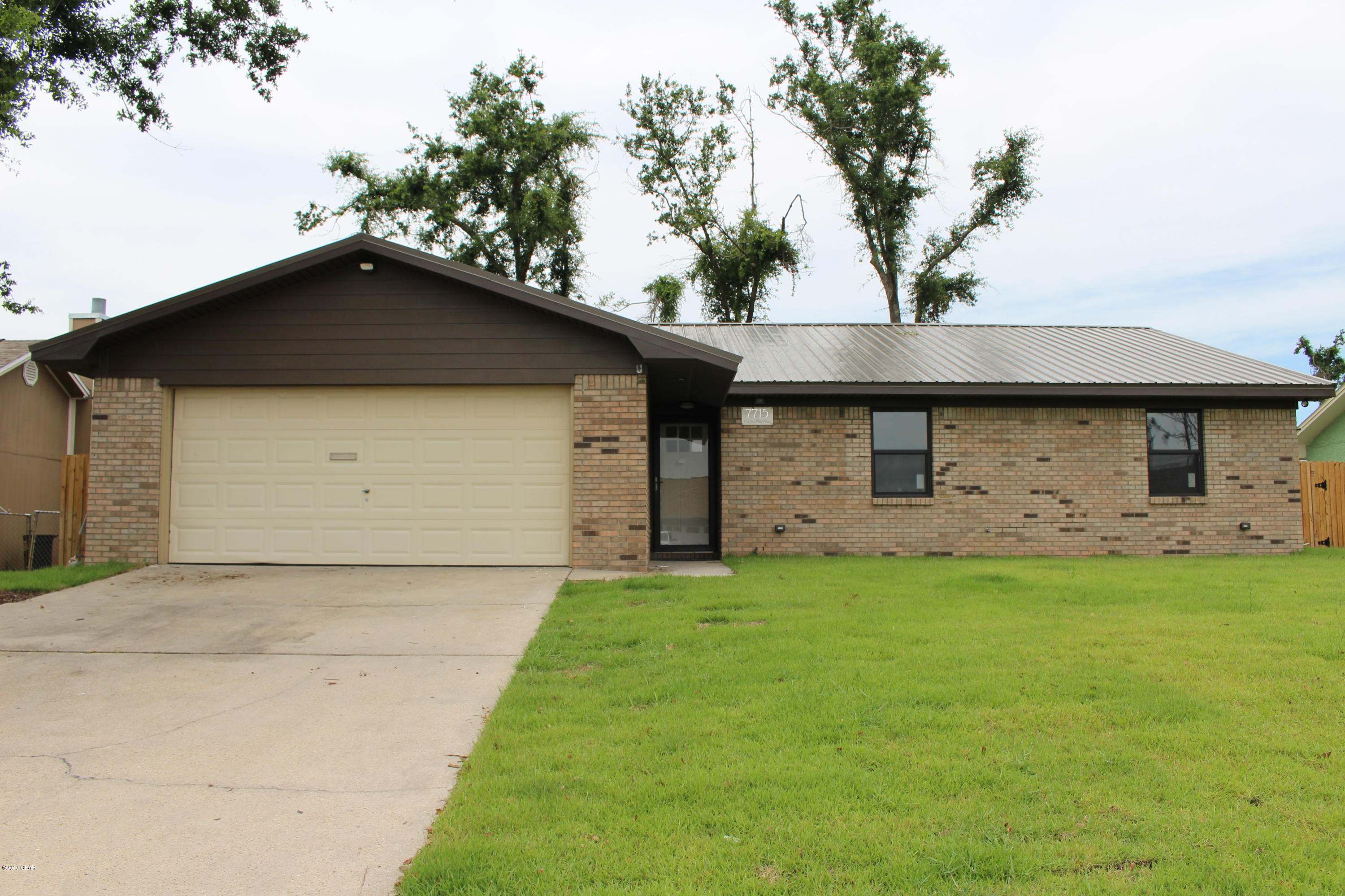Completely renovated energy efficient home only 3.5 miles to Tyndall Air Force Base. With brick frontage and metal roof, the street appeal will impress. As you walk into the home, you will find a large open living space with vaulted ceiling, wood burning fireplace, wood look laminate flooring, granite counters, stainless steel appliances, and glass tiled backsplash. The Master bedroom has track lighting, walk in closet and the ensuite you've dreamed of with marble tiled shower, and double vanity. The 2nd and 3rd bedroom are spacious and have built in cabinets. You'll enjoy the peaceful, fully fenced yard and rear patio area. Double garage features storage cabinets. Rent includes yard maintenance & Pest Control. The owner pays for irrigation water usage. Pets Neg.