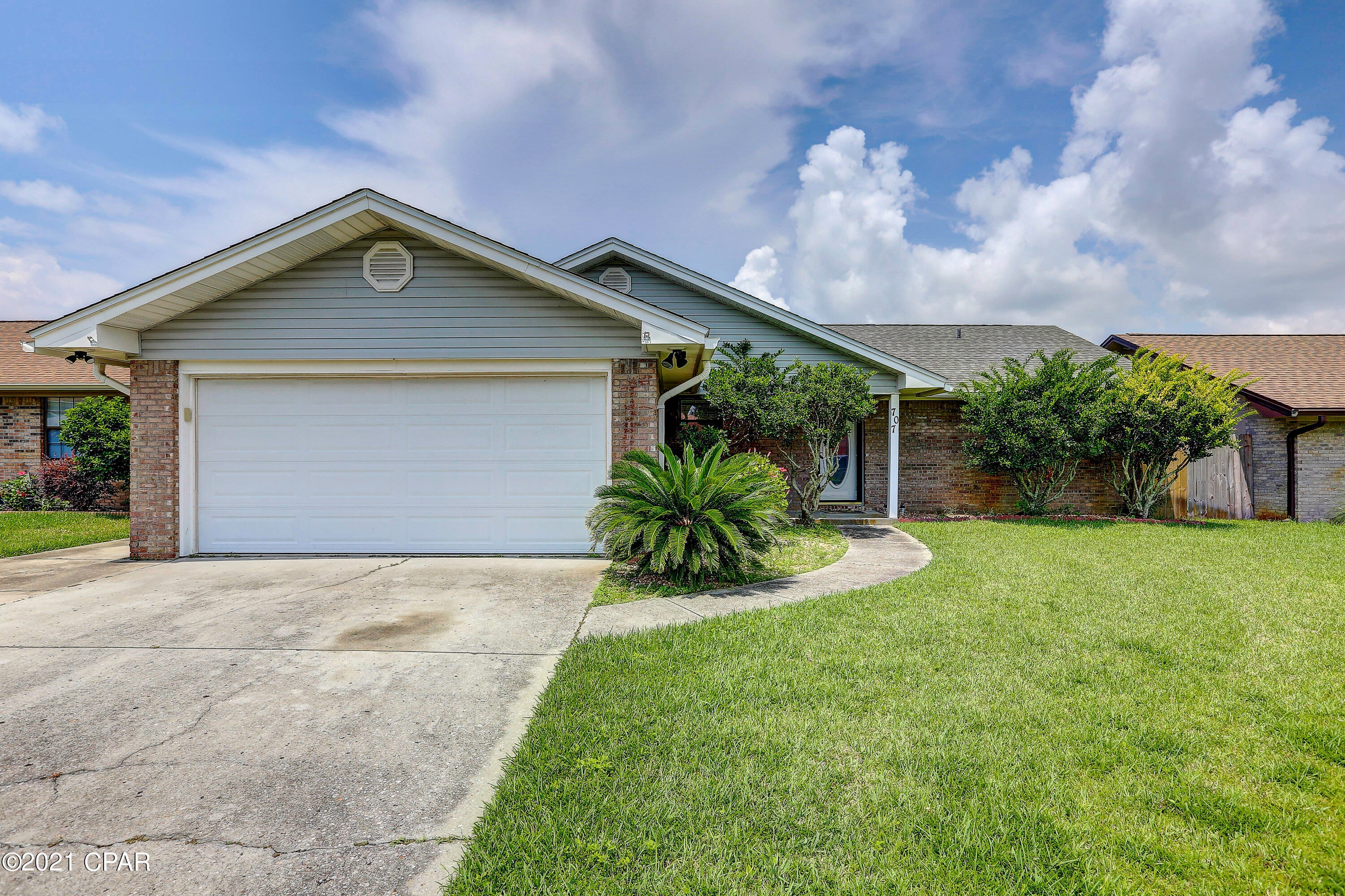 Wonderful move-in ready home, priced right located in a great neighborhood and not in a flood zone..  Close to Tyndall Air Force base, shopping, churches, charter and public schools, boat ramps, beaches and other recreation. No steps with all on one floor, this 3 bedroom 2 bath split plan home has hardwood and tile floors, beamed ceilings and ceiling fans. The kitchen has cherry cabinets, Frigidaire appliances and quartz counter tops. A pass-thru counter to the 17X20 living room features a wood burning fireplace. A large bonus room with natural light off the living room gives wonderful opportunities for entertainment, playroom or additional hobbies. The spacious laundry room between the garage and kitchen is the perfect accent to an excellent floor plan. Easy to love, easy to show. The spacious laundry room between the garage and kitchen is the perfect accent to an excellent floor plan. You will appreciate the walk-in closets found in all bedrooms, including the custom design in the master bedroom closet. The hubby will love this oversize double garage. The rear yard is privacy fenced and ready for children and that special pet. If you are looking for a traditional family neighborhood where everyone takes pride in the appearance of their property, this is it. No association fees and located flood zone X, no flood insurance required. Easy to show, easy to love!