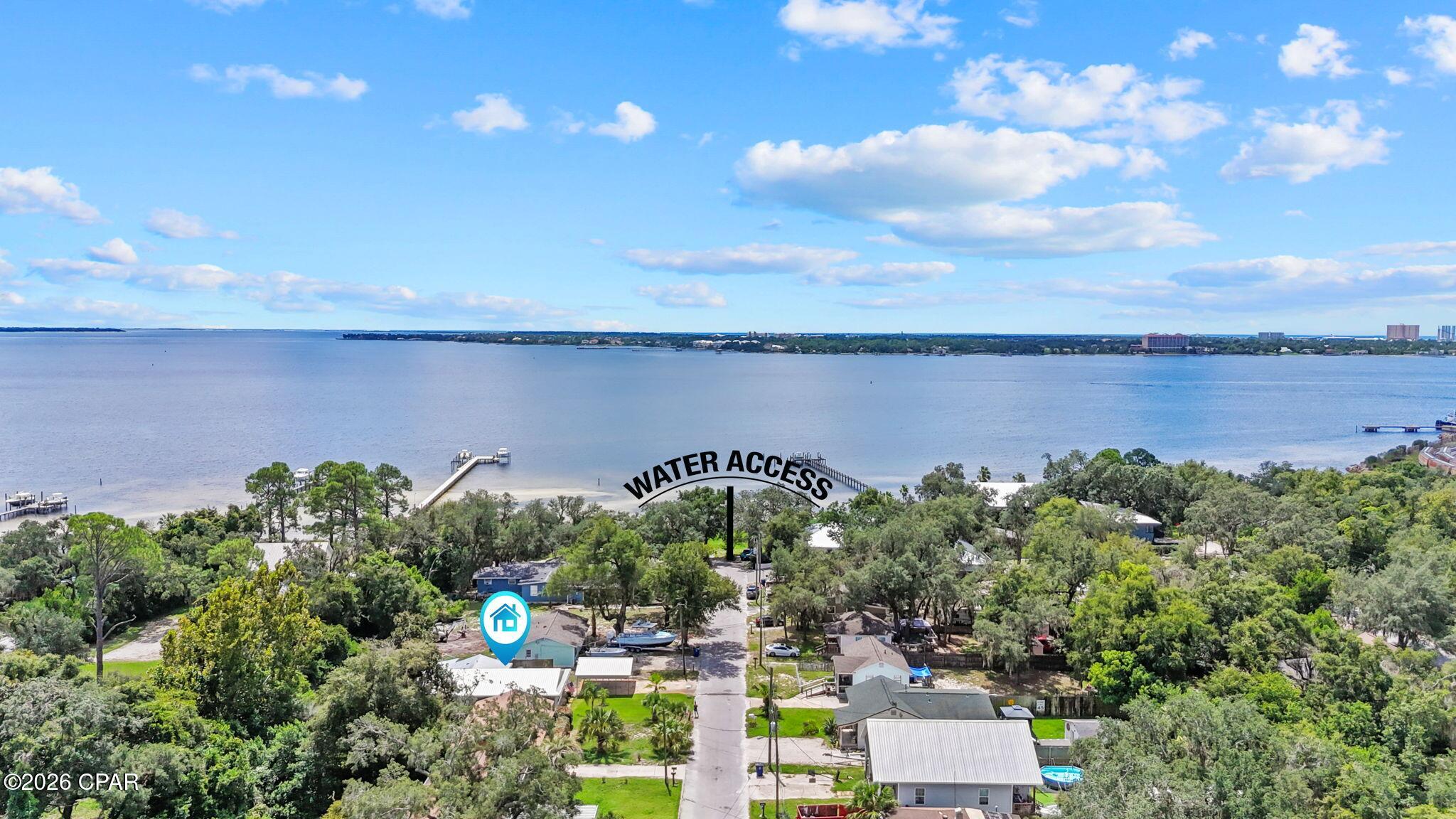 Welcome to this charming Florida cottage, perfectly located just steps from public bay and beach access! This well-maintained 3-bedroom, 2-bath home offers the perfect blend of comfortable indoor living and fantastic outdoor space, with an open layout and plenty of natural light throughout.

One of the biggest perks of this property is its location. Take a short stroll down the quiet street to the nearby public bay access with your kayak or paddleboard and enjoy a day on the water. It's practically bayfront living without the bayfront price tag!

Just off the living room, the expansive 27' x 8' screened-in porch, added in 2021, is the perfect spot to enjoy your morning coffee or unwind in the evening. Step outside to the beautifully appointed backyard, where you'll find an 8' x 10' gazebo. Whether you're hosting a BBQ, entertaining friends and family, or simply enjoying a quiet evening outdoors, this backyard is made for enjoying the Florida lifestyle. A paver walkway and BBQ pad add even more functionality to the outdoor space. There is also an irrigation well pump that helps keep the lawn looking its best. There's also a convenient 6' x 9' storage area off the patio, along with a shed for additional storage.

The home also offers numerous updates, including a metal roof (2017), HVAC (2017), water heater (2018), hurricane impact windows and front storm door (2020), updated plumbing to the street and home (2021), gutters (2021), a screened porch (2021), new bathroom vanities, brand-new walk-in laundry room storage cabinets, a new irrigation well pump (2025), and a newer refrigerator. The covered carport provides convenient parking and plenty of space for boat or outdoor equipment storage.

Inside, the spacious primary bedroom features a convenient en-suite bathroom with a tiled walk-in shower. The second bedroom includes a built-in solid wood shelving unit in the closet, making it an ideal office, study, or guest room. A third bedroom provides a comfortable space for family or visitors.

Perfectly situated near Gulf Coast State College, FSU Panama City, the Navy Base, shopping, dining, and recreation, this home offers an excellent combination of location, updates, and outdoor living. With the bay just steps away and a private, wooded backyard to enjoy, this is a fantastic opportunity to experience the best of the Florida lifestyle.

Don't miss your chance to make this charming coastal cottage your own--schedule your showing today!