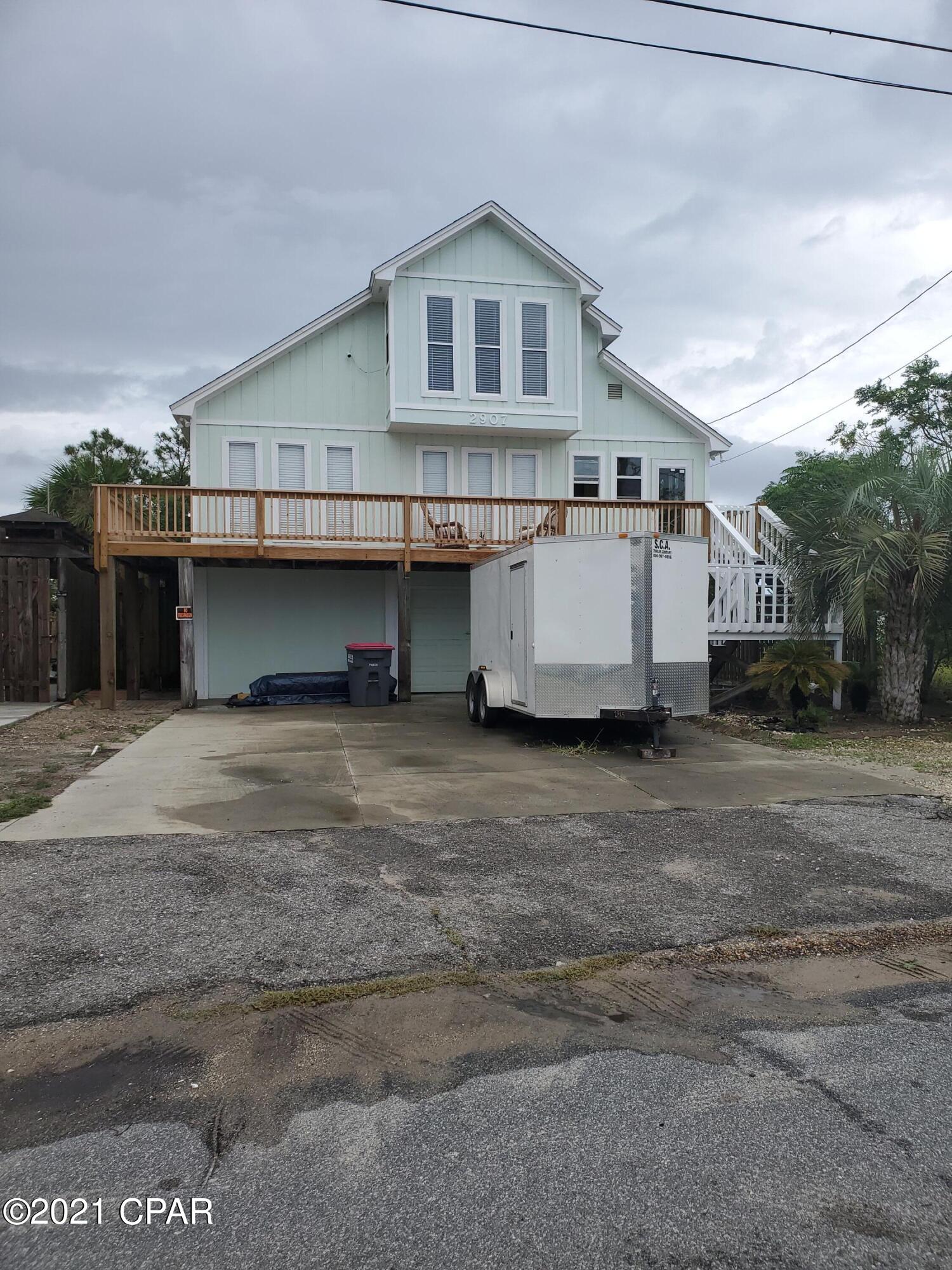 What a great home with endless possibilities!  Walking distance to the beach! The first level of the home has a Mother-In-Quarters with its own entrance, bedroom, bath and kitchen.  This would make a Great short term or vacation rental. The rest of the home is quite spacious with vaulted ceilings, lots of windows and a third level loft. Outside, there is a wrap-a-round deck, a two car carport and a shower to wash off after a day at the beach! Also there is a 16 x20 storage shed in the back yard as well as additional storage under the front porch that is large enough for 4 motorcycles and even a golf cart!