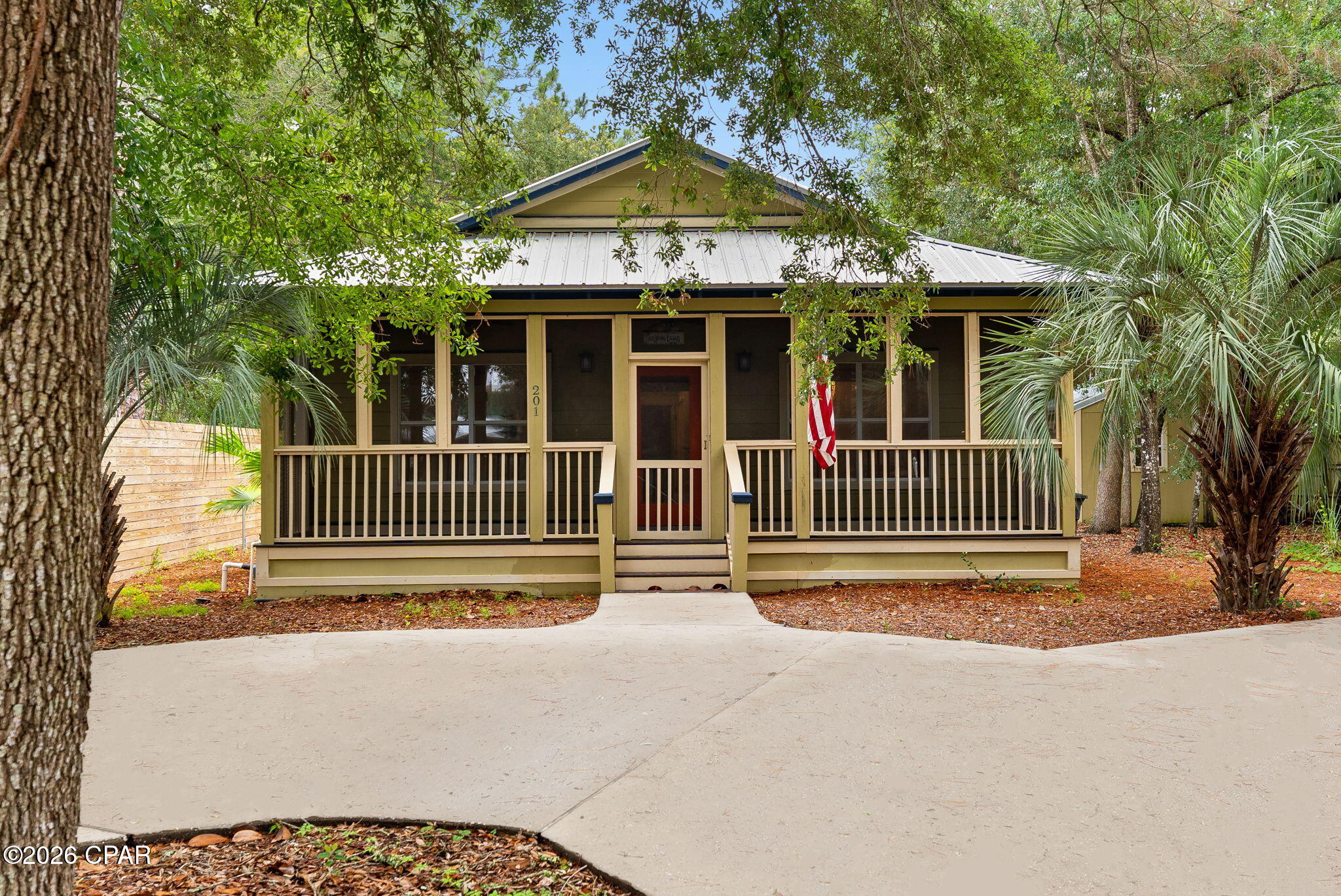 Nestled beneath a canopy of mature oaks in the highly desirable Point Washington community, this charming 3-bedroom, 3-bath coastal cottage offers the perfect blend of privacy, character, and convenience. Set on a wooded homesite just moments from Choctawhatchee Bay and the beaches of South Walton, this home embodies the laid-back Florida lifestyle.

Inside, vaulted ceilings, abundant natural light, and beautiful hardwood floors create an open and inviting living space. The kitchen features stainless steel appliances, ample cabinetry, and a breakfast bar overlooking the spacious living and dining areas, perfect for entertaining or everyday living. The split-bedroom floor plan provides privacy, while the primary suite offers a large walk-in closet and ensuite bath with a soaking tub/shower.

One of the home's standout features is the incredible screened outdoor living area, complete with a wood-burning fireplace, mounted TV, and porch swing, an ideal year-round retreat for relaxing or gathering with friends and family. Additional highlights include a metal roof, covered front porch, storage shed, and a private backyard surrounded by natural landscaping.

Located in the heart of Point Washington, residents enjoy easy access to bayfront parks, boat launches, hiking and biking trails, and the world-famous white-sand beaches of 30A. Whether you're searching for a primary residence, second home, or investment opportunity, this coastal cottage offers a rare combination of charm, privacy, and location.

Coastal living at its finest in one of Santa Rosa Beach's most beloved neighborhoods.