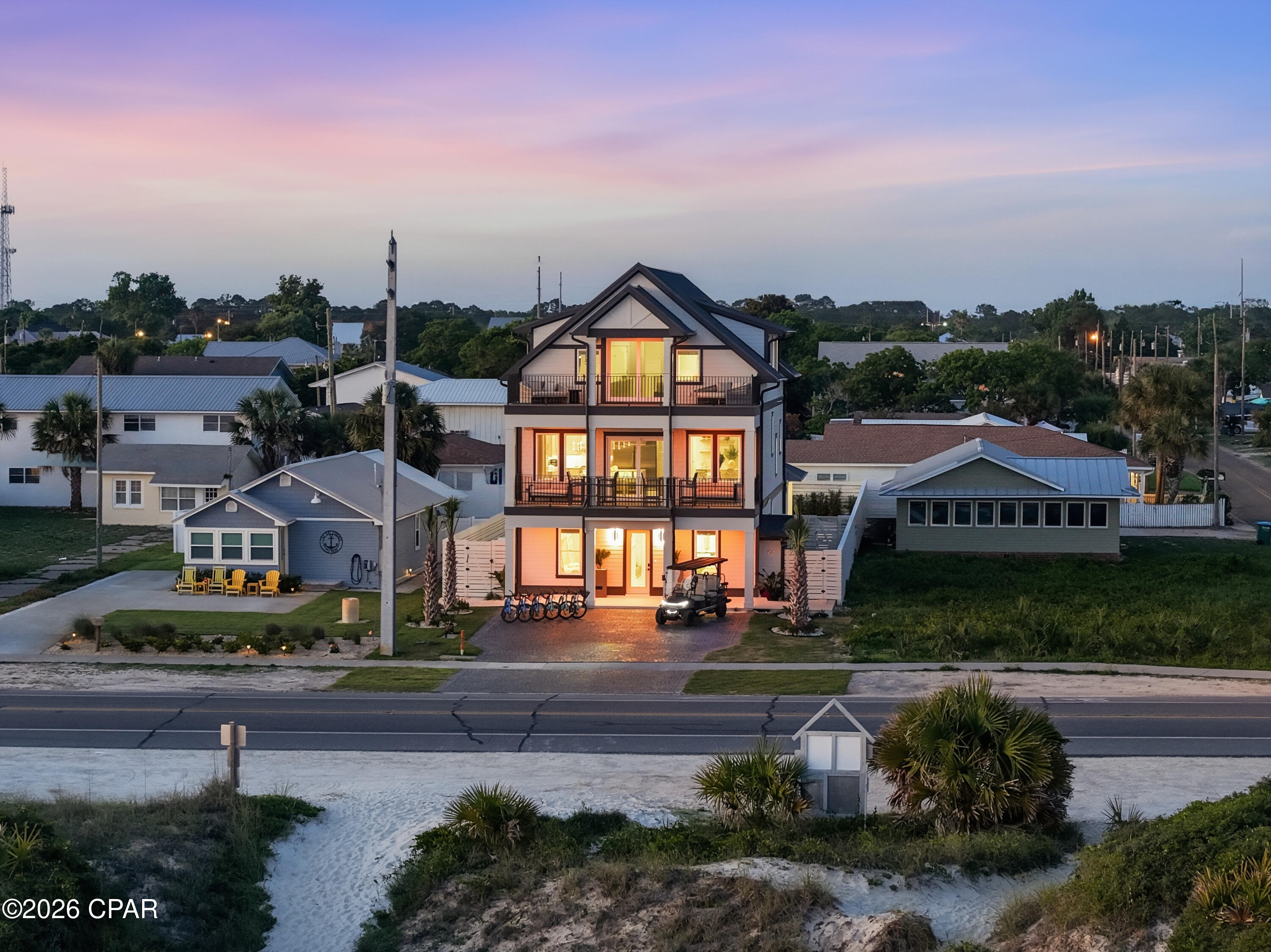 Experience elevated coastal living in this newly completed luxury retreat on the exclusive West End of Panama City Beach. Inspired by the timeless elegance of 30A design, this stunning 7-bedroom residence features 7 full bathrooms, 2 half baths, and a private elevator, comfortably accommodating up to 18 guests. Designed with both luxury and functionality in mind, this fully furnished, turnkey property is ideal as a primary residence, second home, or high-performing vacation rental investment.
Just steps from dedicated private community beach access, guests can enjoy effortless access to the sugar-white sands and emerald waters of the Gulf. The home's resort-style outdoor living space is truly exceptional, showcasing an oversized pool, expansive sun deck, and a fully equipped outdoor kitchen built for entertaining on a grand scale. The outdoor bar area includes a built-in grill, refrigerator, ice maker, premium sound system, and generous gathering space perfect for family reunions, weddings, and corporate retreats. Inside, the thoughtfully designed floor plan offers spacious accommodations across three levels. The first floor features three custom bunk rooms and a large recreation room ideal for entertaining guests. The second floor serves as the heart of the home with an expansive open-concept great room, designer kitchen, and two additional guest bedrooms. The third floor hosts two luxurious primary suites, including one with beautiful Gulf views and another overlooking the private outdoor oasis.