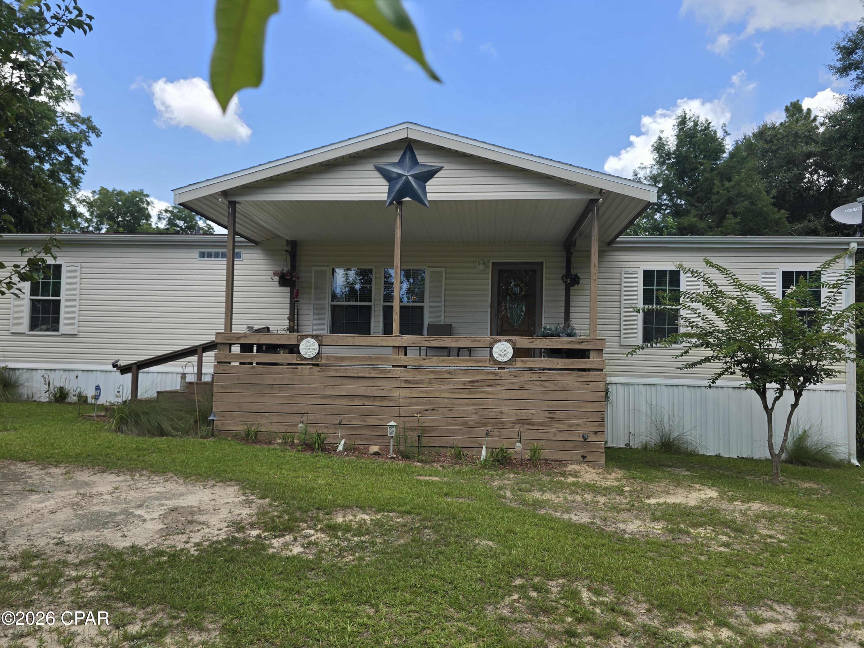 Welcome home to this spacious, well-maintained double-wide manufactured home in the desirable Chipley area.
Conveniently located with highway frontage, this property offers easy access while still providing plenty of room to enjoy both indoor and outdoor living.  
Inside, you'll find a bright, open layout featuring beautiful oak kitchen cabinets, stainless steel appliances, and ample cabinet and counter space. 
The primary suite offers a relaxing retreat with an electric fireplace in the bathroom, creating a warm and inviting atmosphere.  
A built in desk with shelving in the hallway provides the perfect space for a home office, study area, or organization station.
Step outside and enjoy the large front and back decks - ideal for entertaining, grilling, or simply relaxing with your morning coffee. 
An outdoor work shed provides additional storage and workspace for hobbies, tools, or lawn equipment.
If you're looking for a move-in-ready home with comfort, convenience, and plenty of functional space, this Chipley property is one you won't want to miss.