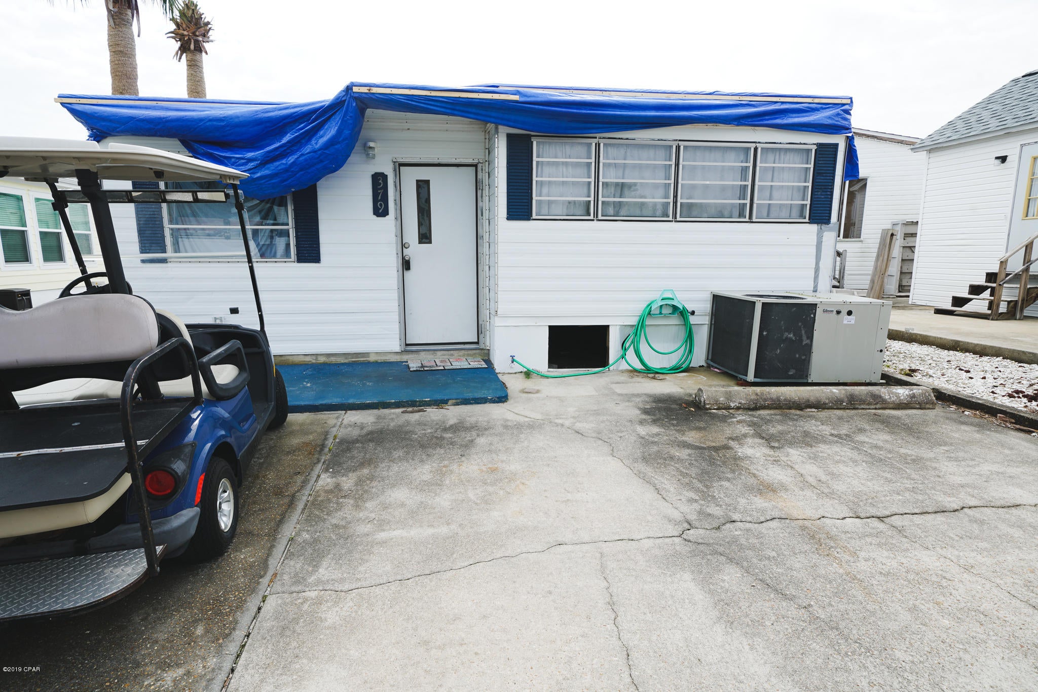 Home has hurricane damage, water damage, etc.  Needs roof, flooring, etc. Tear down and build your dream home or renovate. You decide! Sold AS IS. Venture Out has 300' on the beautiful pristine beaches of the Gulf of Mexico and 1,000' on the Grand Lagoon. Venture Out has something for everyone. With two salt water pools (one heated), fishing pier, boat ramp, mini golf, children's play ground and much more!