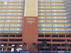 This beachfront penthouse, located on the west end of Panama City Beach, is in immaculate condition, professionally decorated, and includes all furniture, furnishings and many upgrades to include washer and dryer. This is a rare opportunity to own a penthouse in Tropic Winds. Part of the beach side heated pool is located inside with the other part being outside. There is also a beachfront hot tub for your enjoyment. The seller bought this penthouse new and rented it the first year; thereafter making it his primary home. Prior rental history is available upon request. The penthouse includes two assigned parking spaces, number P1-40 and P02-14.