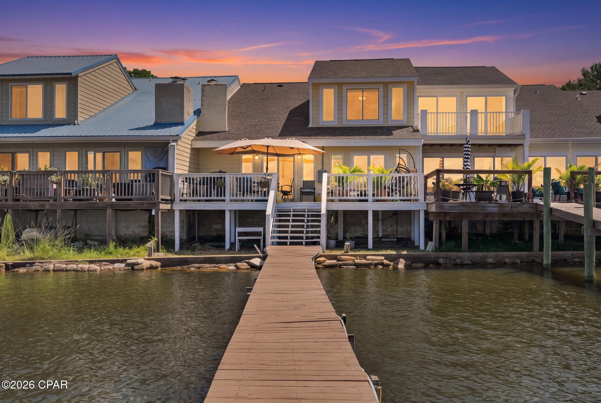 Beautiful sunsets-check.  Bayfront living-check.  Private dock-check.  Gulf access-check.  Welcome to your own slice of paradise. 
This 3 bedroom, 2.5 bath townhome offers an open living space highlighted by vaulted ceilings with exposed wood beams, low-maintenance  tile flooring, and a floor-to-ceiling stone fireplace. The kitchen is outfitted with granite countertops, a breakfast bar, solid wood cabinetry, decorative tile backsplash, and stainless steel appliances.  Sliding glass doors lead out to a waterfront sun deck overlooking the bay, ideal for outdoor entertaining and sunset views. 
Centrally located in Panama City near waterfront parks, local dining and shopping, this attached single-family home is minutes from Tyndall Air Force Base, NSA Panama City, Panama City Beach and St. Andrews State Park. Whether serving as a primary coastal residence, an investment property, second home, or a boat-ready vacation retreat, this Bay County waterfront property offers unmatched access to the Florida Gulf Coast lifestyle.

Buyer to verify measurements if important.