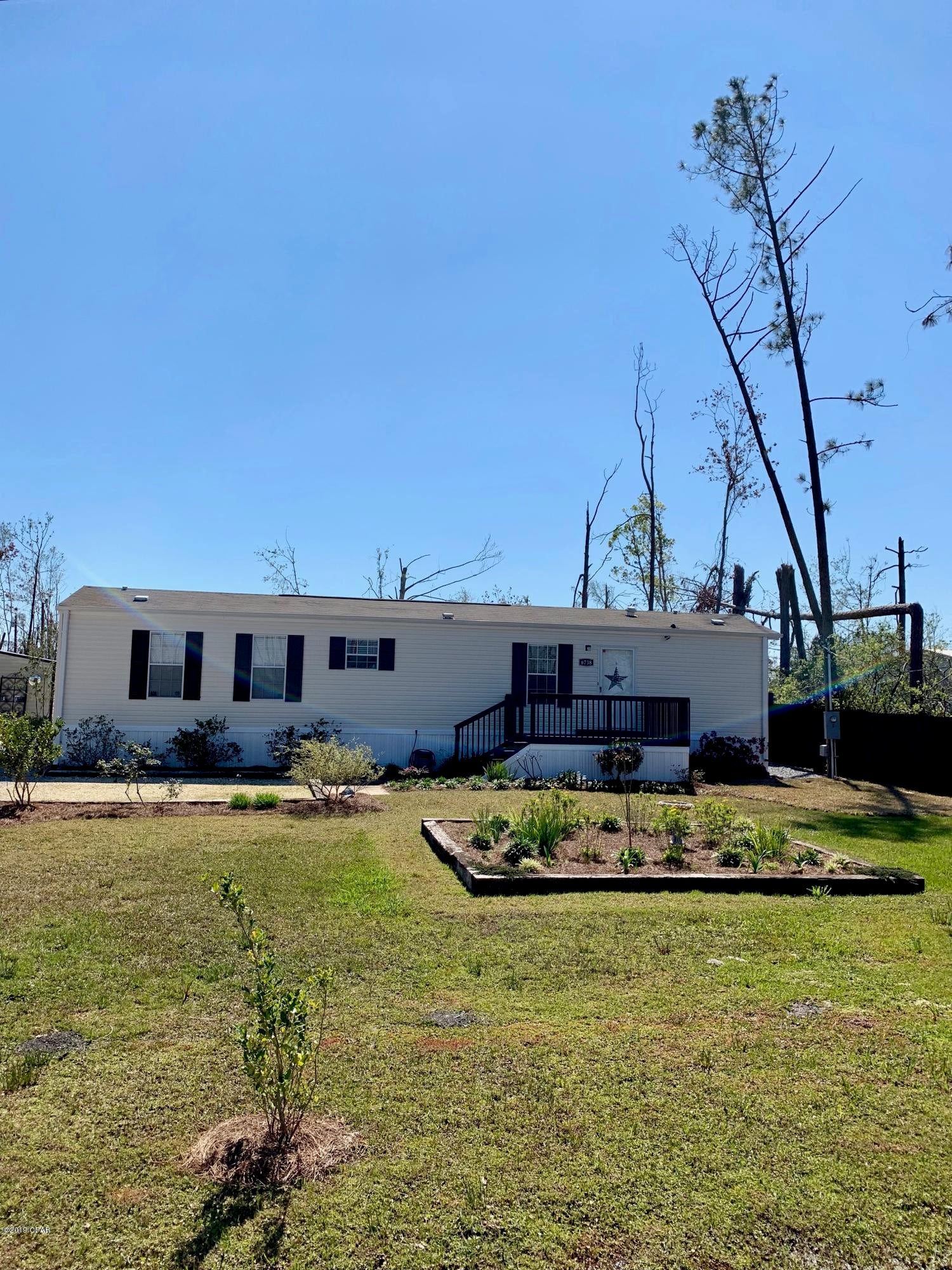 CURRENTLY UNDER CONTRACT, SELLER ACCEPTING BACKUP OFFERS Affordable, immaculate, move in ready home on a little over a half acre!  This one won't be here long - check out this great home already converted from a mobile home to real property.  This 2012 home has two bedrooms and two baths and is all electric, on public water and sewer!  The bedrooms are on opposite sides of the home.  The great room is open to the kitchen and dining area.  The washer and dryer stay in the laundry room along with all appliances including the refrigerator (with ice-maker) and microwave).  The master has an en suite bath with a double vanity, and a shower with two benches built in.  His and hers closets make for good storage in the master as well. 

There is an 8x12 front porch and an 18x20 covered deck in the back.  There are manicured flower beds showing the pride of ownership, beautiful even after the Hurricane.  Two out buildings both have power, and automatic dusk to dawn lighting.  The front porch has this lighting as well.  Other features - the home has whole house ventilation - even when the air conditioner is off, there is air circulating through the vents above the doors - this can really save on your power bill.  Something you can't see - there is a "pump grinder" which grinds waste and pumps to the sewer system - all underground.  
Exclusions - Draperies and rods in Master Bedroom, Living Room, and Guest Bedroom DO NOT CONVEY.  All blinds and other curtains do stay for the buyer.  
If this sounds like the home for you - please call your Realtor and get in to see it before it's gone!