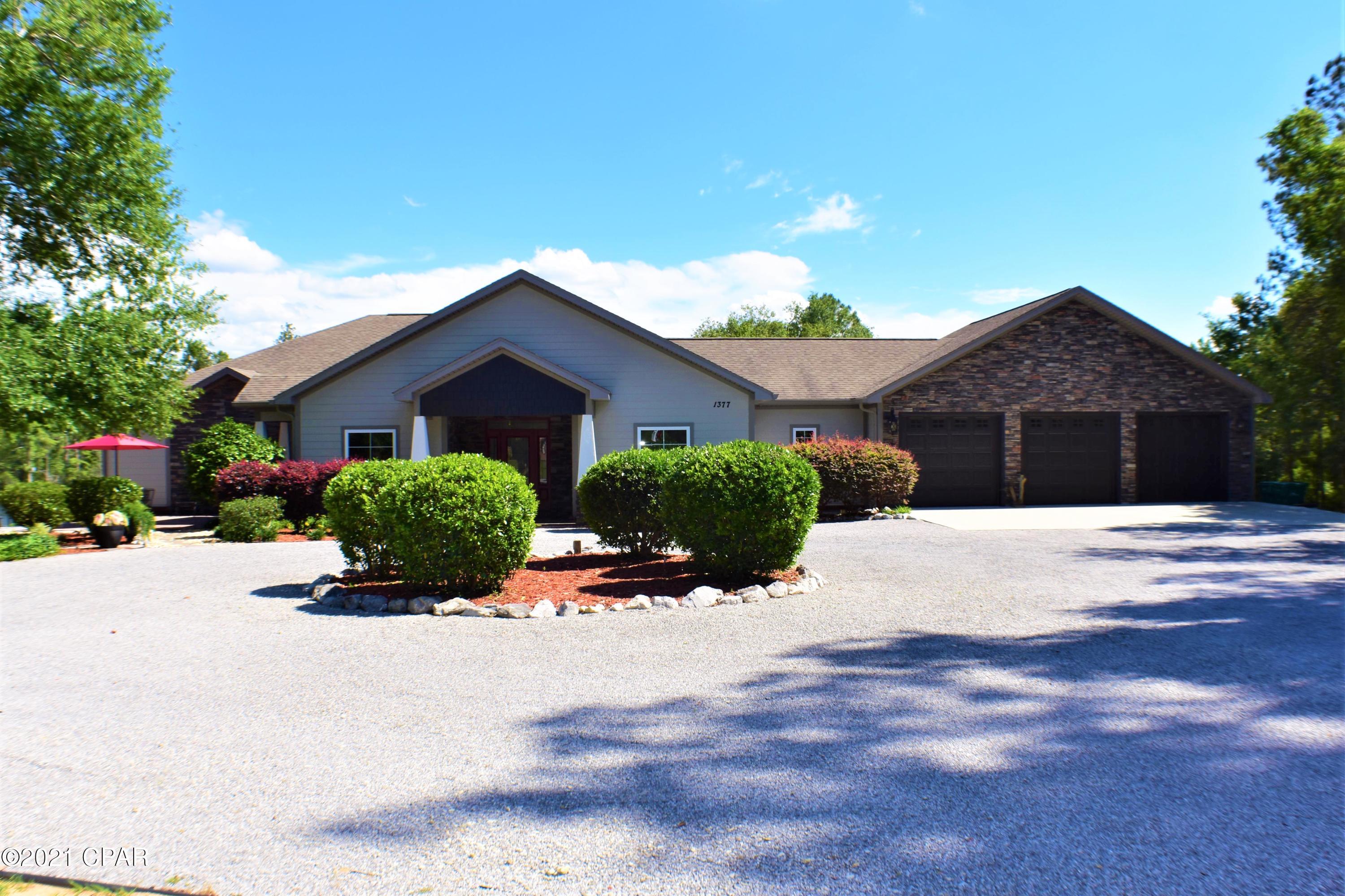 CURRENTLY UNDER CONTRACT, SELLER ACCEPTING BACKUP OFFERS.  Leave the traffic behind with this beautiful waterfront paradise on Gin Lake in Sunny Hills!  This 4BR/3.5BA custom designed Craftsman home was built for a growing family yet perfect for entertaining!  You'll love the views of the lake & there is approx 350' of waterfront, a dock, fire pit, fish cleaning & grilling station, garden area with picnic table, putt-putt course, & an in-ground pool!  The interior boasts a split-bedroom floor plan, formal dining room, living room, den, large open kitchen with breakfast nook, & a sunroom with its own kitchenette!  All high-end stainless steel appliances including ice maker, convection oven, gas range with air fry oven, & there isn't an ounce of wasted cabinet space in the kitch living area and a coffee station in the master bath!  The 5th bedroom could also be used as a hobby room or for extra storage, not that you need it thanks to the abundance of closet and attic space, the three car garage and the separate barn!  Additional features include an outside shower, whole house Generac generator, and a circular driveway.  The landscaping is gorgeous and the seller is leaving his lawn mowers and tools behind!  This is a dream home with all the bells & whistles and you need to see it in person!  The area across the lake is a greenbelt area so per the sellers, no other homes can be built on that side of the lake.  There is a public boat ramp across the lake and gas and electric motors are allowed.  Sunny Hills is a golf course community with several lakes and picnic pavilions, and best of all, even though you're away from the city, you're only 30 minutes from town and the new airport!   All info is approx and must be verified by Buyers if important.
