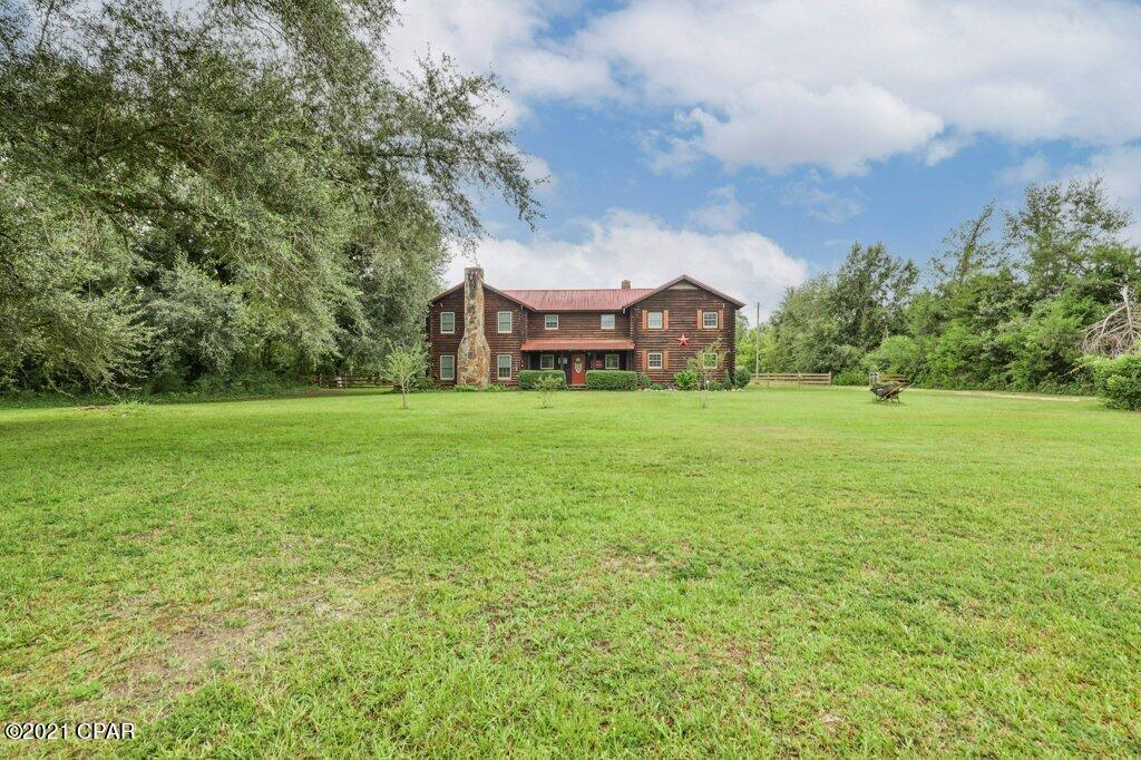 CURRENTLY UNDER CONTRACT, SELLER ACCEPTING BACKUP OFFERS.  Great log cabin home in Bristol FL, close to new school yet with plenty of land to plant your garden and have privacy.  This home has 3 covered porches for you to enjoy the early mornings to the late evenings.  There is a storage barn on the back side of property for your lawn mowers, boats, 4x4's and an enclosed storage shed for your own workshop.  The Apalachicola River boat ramp is only about a 5 minute drive away and the Memorial park is only a 2 minute drive away.  Don't miss this chance to have a large home in a great location with land for under $300K.