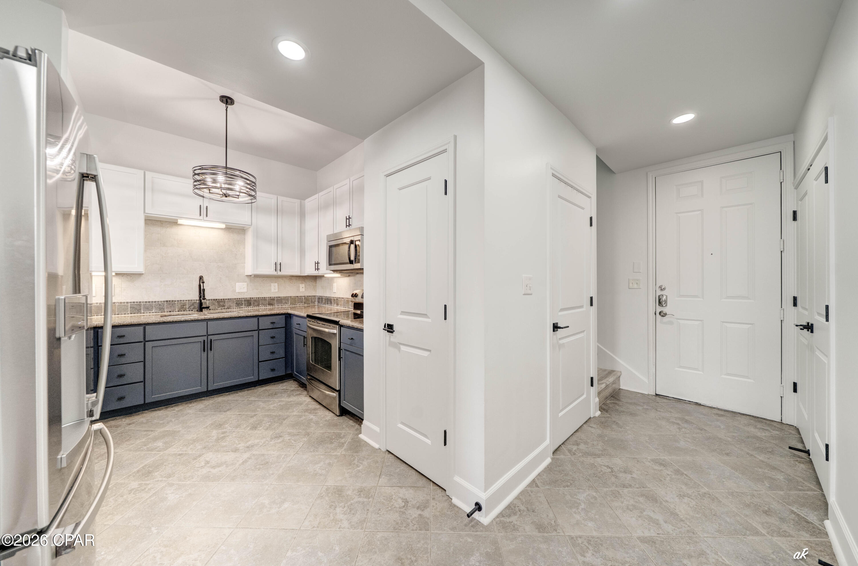 Welcome to your completely renovated Panama City condo, where modern design meets effortless coastal living. Every detail has been thoughtfully updated, creating a truly move-in-ready home with high-end finishes throughout.

Step inside to discover brand-new luxury vinyl plank flooring throughout the living areas, second floor, stairs, and closets, complemented by fresh interior paint on the ceilings, walls, trim, cabinetry, and built-ins. The open living spaces are enhanced with all-new recessed lighting, updated ceiling fans, stylish light fixtures, and floor-to-ceiling double-layer blackout curtains in both the living room and primary bedroom.

The beautifully updated kitchen features freshly painted cabinetry, new pendant lighting, a new flush-mount ceiling fixture, a new sink, and a brand-new refrigerator, offering a clean, modern space that's perfect for everyday living or entertaining.

The primary suite has been transformed into a luxurious retreat with dual sinks, elegant chandelier lighting, custom vanity trim, and a professionally designed walk-in closet complete with furniture-grade built-ins, custom shelving, double-hanging storage, black closet rods, and dedicated his-and-hers organization. The hall bathroom has also been tastefully updated with a new sink, vanity enhancements, and a new toilet, while both bathrooms feature brand-new toilets.

Additional upgrades include a custom office with a newly added interior window opening, trim detail, and additional electrical outlets, along with new shoe molding throughout, professionally repaired drywall, and meticulous finish work that gives the entire condo a fresh, polished feel.

From top to bottom, this extensive renovation leaves nothing to do but move in and enjoy everything Panama City has to offer. Whether you're looking for a full-time residence, vacation getaway, or investment opportunity, this turnkey condo offers exceptional style, quality, and value in one beautifully updated package.