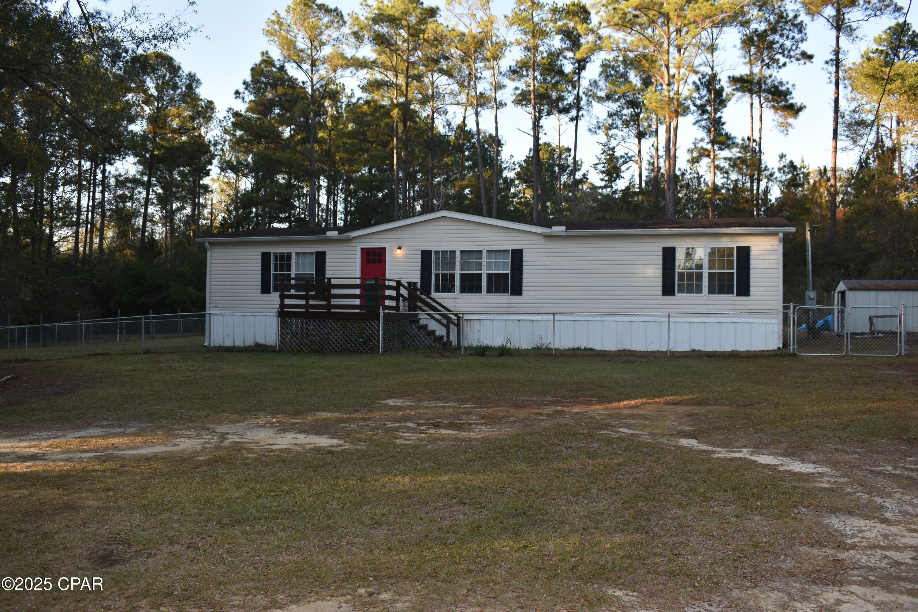 Experience the charm of country living with the roomy 3-bedroom, 2-bath doublewide mobile home.  
As you walk through the front door you will see the expansive living room,  
dining area with views of the back porch and yard, lots of kitchen cabinets and a cozy breakfast area. With a split bedroom plan the generous master bedroom features an ensuite bathroom with a shower and a double sink vanity.
The two extra bedrooms are large and has large closets.
The outside features some chain-link fencing that encloses part of the front yard and the backyard.
With two acres you have plenty of room for your dog etc to run around.
The property has paved road frontage.