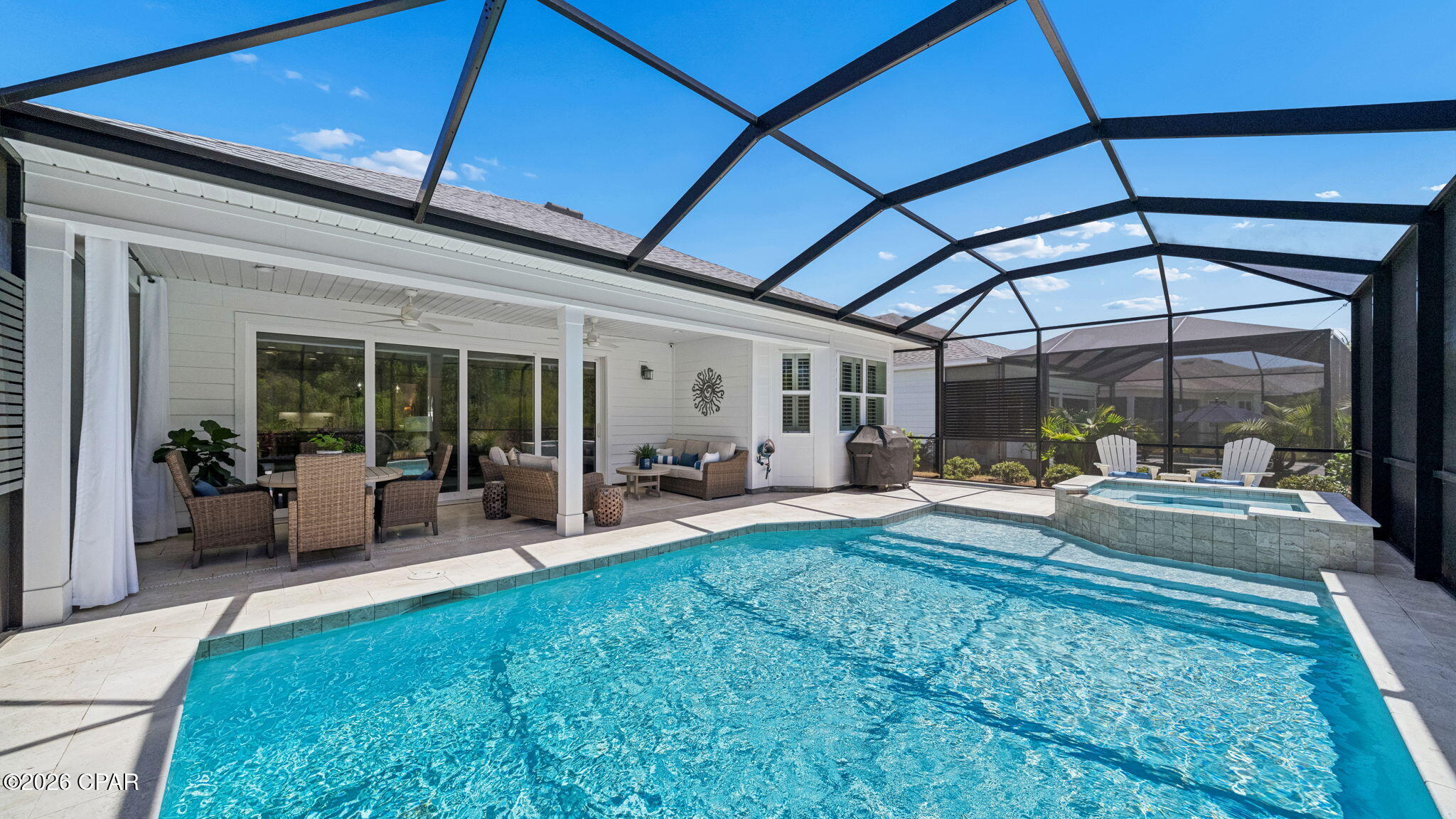 Welcome to this thoughtfully appointed Cabana Bay model on a preserve lot, located in sought-after Phase 3 of Latitude Margaritaville Watersound, a short golf cart ride to the vibrant Town Square where activities abound. This meticulously maintained move-in-ready home is where modern elegance meets coastal charm. Inside this light-filled, open-concept layout you'll find a gourmet kitchen full of upgrades featuring quartz countertops, a gas cooktop, (kitchen fridge conveys), wall oven, microwave, wine fridge, under cabinet lighting, and range hood perfect for entertaining around the oversized island that easily seats 6. The living room abutting the dining area features ceiling beams and expansive glass slider doors that open to your outdoor oasis. The large primary suite features his/her closets while the ensuite bath offers dual vanities, quartz countertops and a zero entry tiled shower. Two additional bedrooms are separated by a tasteful bathroom with tiled shower/tub combination. The home also features a den/flex space with built-ins perfect for an office, guests, or additional living space while the laundry room offers upper cabinets for all your laundry items. Fire up the grill and entertain in your private oasis pool area featuring beautiful Travertine pavers, recently sealed, and newly installed metal panels offering additional privacy. Other mentionables to note are plantation shutters, crown molding in the living areas, 5 ½'' baseboards, a whole house water filtration system and newly epoxied garage floor. HOA fees include lawn care and landscaping allowing you more time for fun. Residents of Latitude Margaritaville Watersound enjoy world-class amenities including: a bandshell with music Friday and Saturday nights, Paradise Pool, Bar & Chill restaurant with 2nd floor Overlook Bar with views of the Intracoastal Waterway, fitness center with indoor lap pool, pickleball, tennis, basketball and bocce ball courts, Workin' N' Playin' Center featuring a dog spa, theater, woodworking shop and arts & crafts studio, dog park, daily activities, concerts, events, walking/biking trails and golf-cart friendly paths. You'll be just minutes to a new public marina, Publix, shopping, dining, nail salon and much more currently being built for even more convenience while just down the road a few miles is the new FSU/TMH medical campus with a new hospital currently under construction. Find your slice of paradise here and start enjoying resort-style living in this premier 55+ community, approx. 7 miles to the sugary white sand beaches of the Gulf!