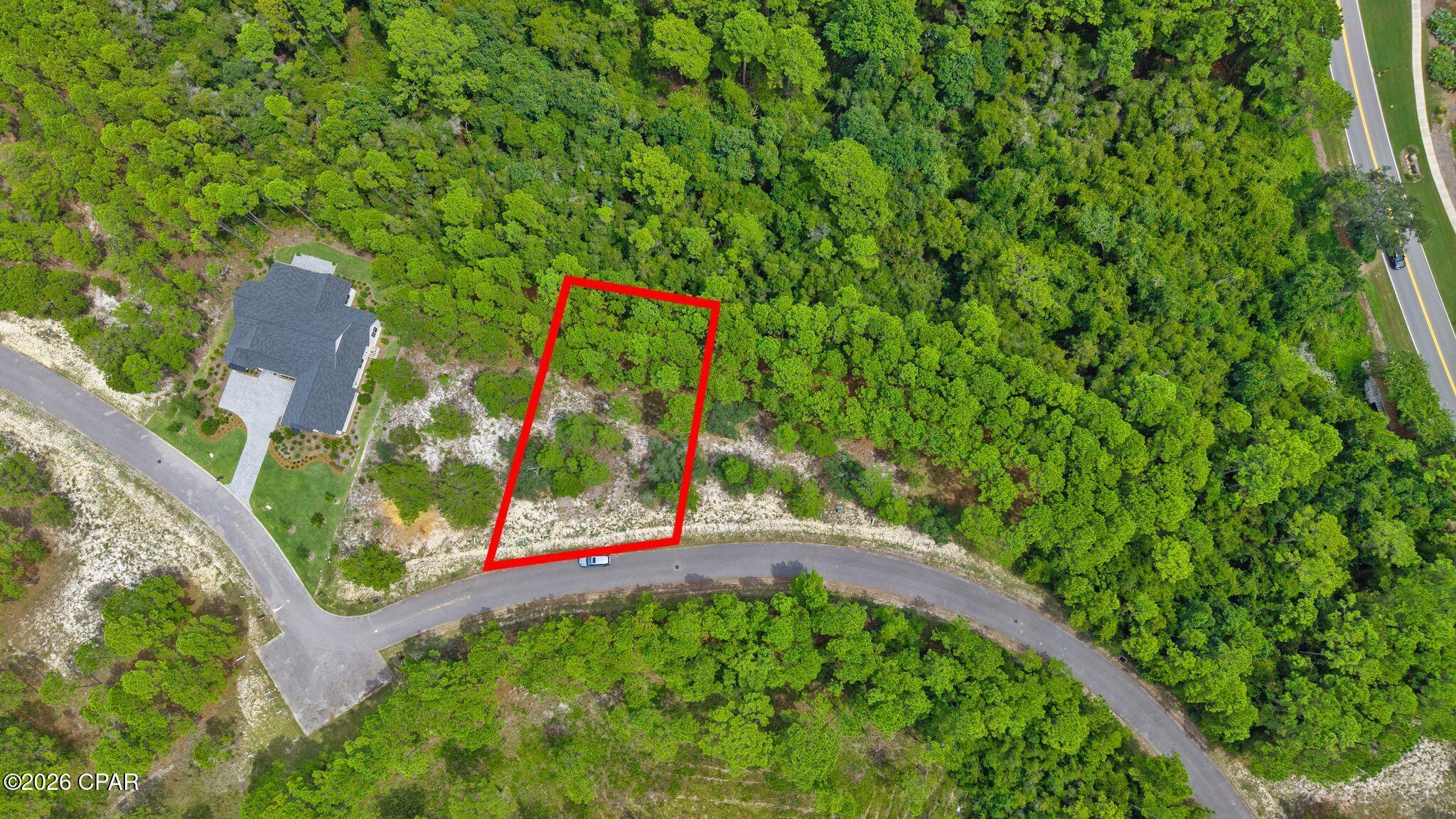 Exceptional 0.26-acre homesite in the prestigious gated community of Wild Heron! Located at 1522 Sweetbay Trail, this spacious lot offers privacy, mature pines, and a peaceful natural setting, perfect for building your custom coastal retreat. Enjoy resort style amenities including a lakeside pool, hot tub, fitness center, fire pit, pavilion, grills, playground, walking and biking trails, and the Boathouse with kayak and canoe access to Lake Powell, Florida's largest coastal dune lake. Wild Heron is also home to the Greg Norman designed Shark's Tooth Golf Club. Conveniently located minutes from the Gulf's white sand beaches, 30A, Pier Park, dining, shopping, and Northwest Florida Beaches International Airport. Build your dream home and enjoy the exceptional lifestyle Wild Heron has to offer!
