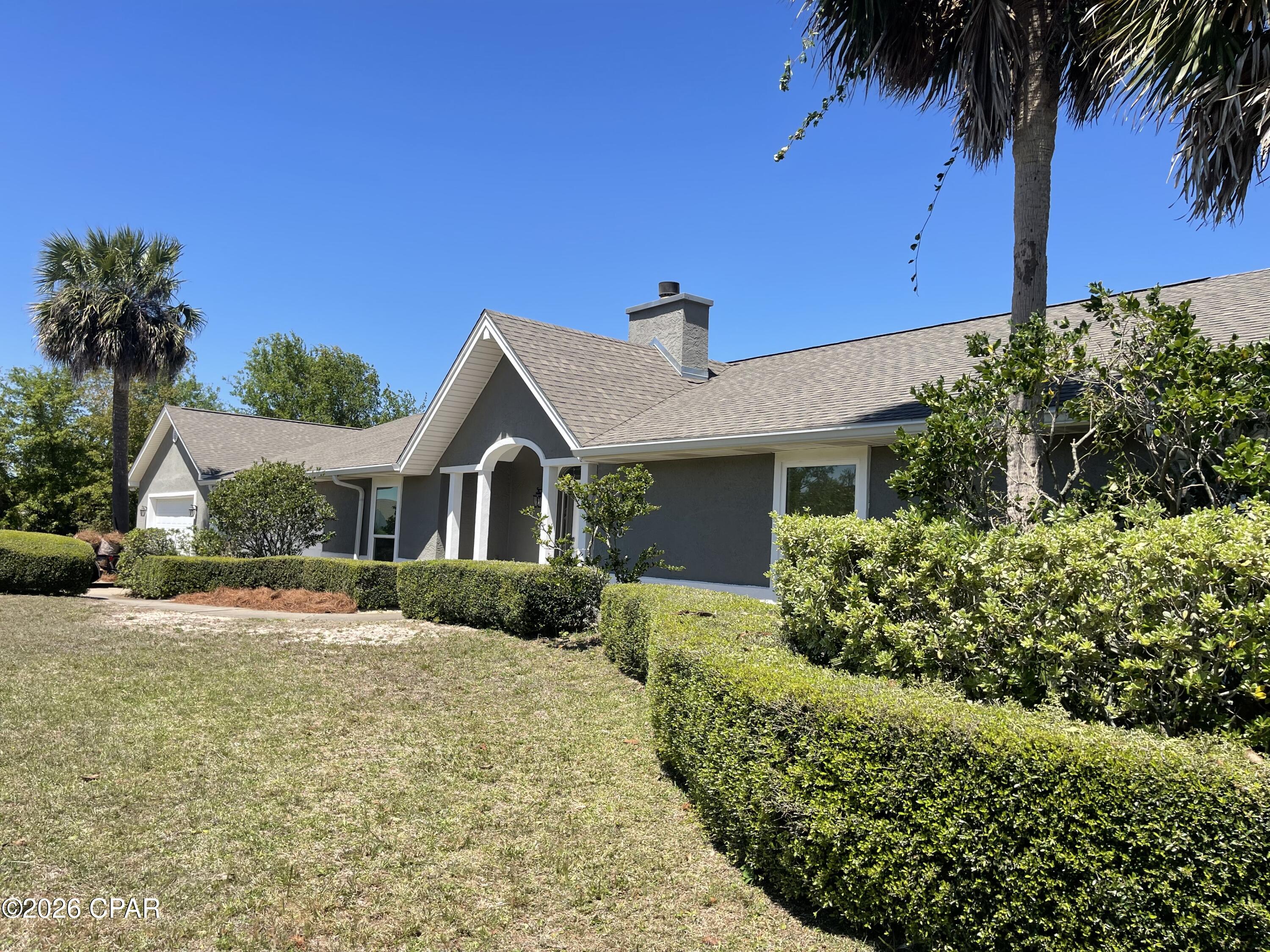 PRICE IMPROVEMENT!! Motivated sellers!!
Set on a generous 0.83-acre corner lot in one of Lynn Haven's most desirable subdivisions, this property is a dream come true for anyone with a passion for RVs, ATVs, jet skis, boats, classic cars, or hands-on workshop hobbies. A six-foot vinyl privacy fence embracing the entire back yard belongs with the property and is not shared. With a pole barn, a detached garage that can accommodate up to four vehicles or be transformed into a full workshop, plus an attached two-car garage, you'll have all the room you need for storage, tinkering, and adventure-ready gear.

Inside, the home blends comfort with functionality. A cozy fireplace anchors the living space, while a stunning sunroom overlooks your custom saltwater pool--complete with a rock waterfall feature that creates a peaceful, private retreat after a long day outdoors. The spacious kitchen is built for those who love to cook, offering double ovens, a farmhouse sink, and brand-new stainless-steel appliances. A large laundry and pantry area provides abundant storage, and the stackable washer and dryer convey with the home.

The bedrooms are generously sized, and the en suite bathrooms feature luxurious custom walk-in showers. Efficiency is built into every corner: the AC system, heat pump, water heater, and pool pumps are all high-efficiency units designed to save you money. The brand-new AC system includes new ductwork and balanced return air in every room for optimal comfort.

Whether you're hosting friends in the sunroom, relaxing by the pool, or gearing up for your next outdoor adventure, this Lynn Haven home offers the perfect blend of space, comfort, and hobby-friendly amenities. It truly has it all.