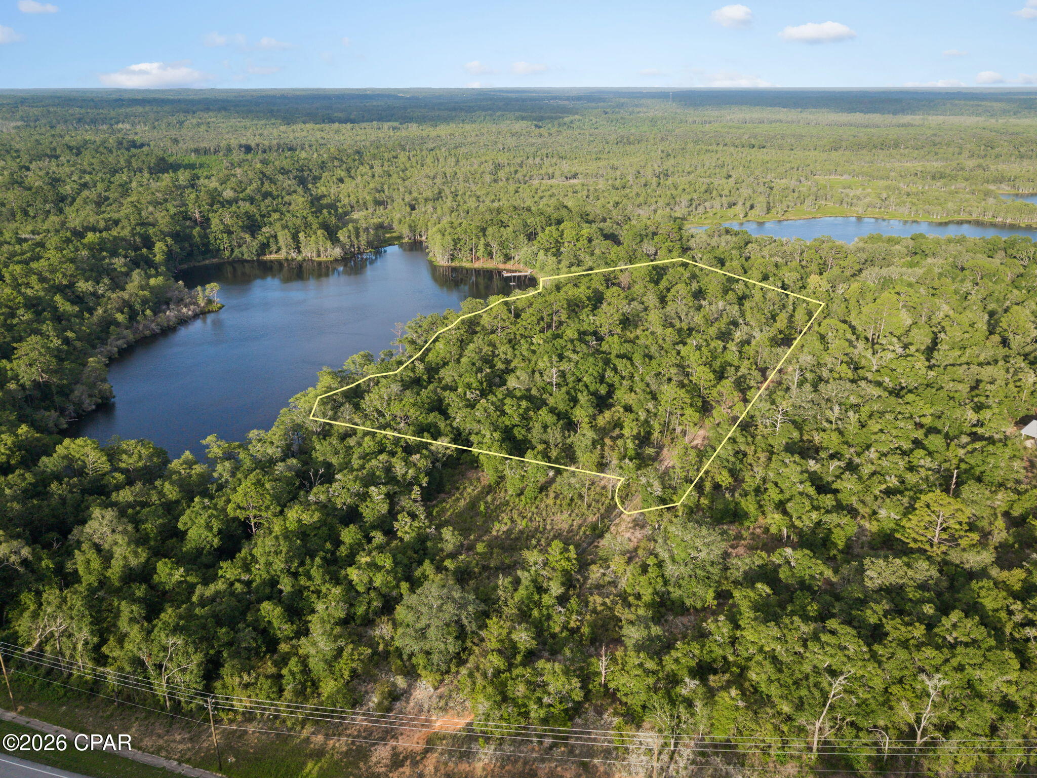 For decades, Horselot Pond has been a quiet sanctuary for the Arnone family -- a place of peaceful water views, natural beauty, and lasting memories. Now this rare multi-lot offering invites you to create your own private retreat. With the platted (but not installed) Rio Vista Road included, the property provides a wide-open canvas for your vision, whether you're dreaming of a nature-inspired homestead or a secluded getaway. No build time requirements and no mobile homes ensure long-term quality and flexibility as you plan your future here.

Conveniently located near local schools, the spring-fed waters and recreation of Holmes Creek, and the shopping, dining, and coastal amenities of Panama City Beach. Owner financing available with 20% down.