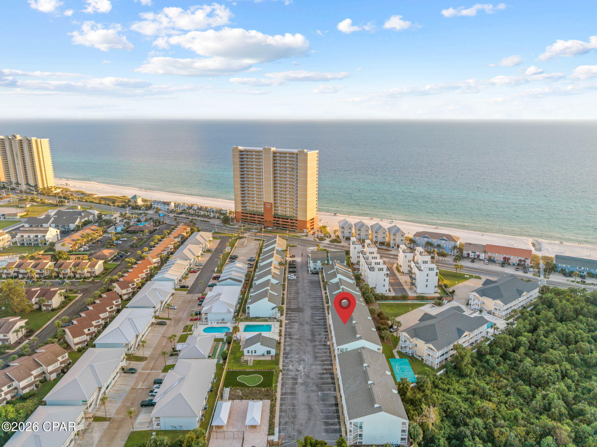 Welcome to your perfect beachside retreat! This charming 2-bedroom, 2-bath condo is just a short stroll from the pristine shoreline, offering an ideal getaway for relaxation or adventure! Inside, you'll find a spacious living area seamlessly connected to the kitchen, making it perfect for entertaining and creating lasting memories. The generously sized master bedroom features a walk-in closet and an en suite bath, offering a private place to unwind after a day in the sun. Enjoy your mornings on the oversize front porch with a cup of coffee and spend the afternoon keeping an eye on the kids playing in the pool. Southwind has even more to enjoy with recently updated outdoor amenities, including new pickleball courts, picnic areas with tables and grills,  putting green, and a beautifully renovated clubhouse. Perfectly positioned on the west end of Panama City Beach, this property is approximately 2.2 miles from Pier Park and just a short drive from the vibrant communities of 30A. Whether you're searching for your own coastal getaway or an investment property with rental income potential, this Southwind condo offers a great combination of location, amenities, and easy access to the beach!
