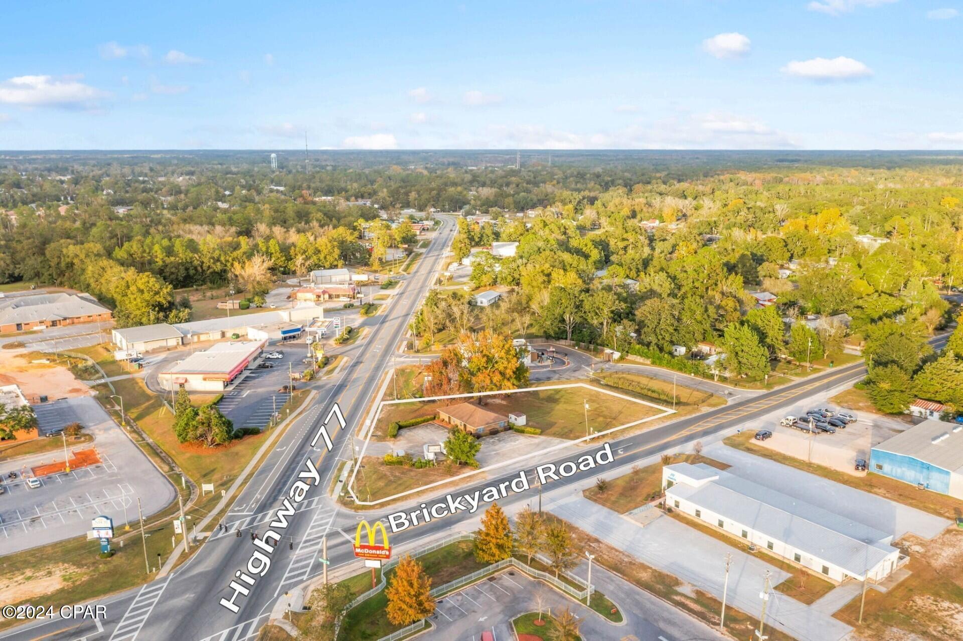 Seize the chance to position your business in a high-visibility location. Boasting Hwy 77 and Brickyard Road frontage, this 0.768± acre property features excellent exposure with an average daily traffic count of 14,500 (2023 DOT data), ensuring steady visibility and potential customer reach. The flexible layout of this commercial building is ideal for a range of businesses, from retail and professional offices to service-based enterprises. Its prominent location and ample frontage create an exceptional opportunity to attract foot and vehicle traffic alike. Don't miss out on establishing your business in this prime location!