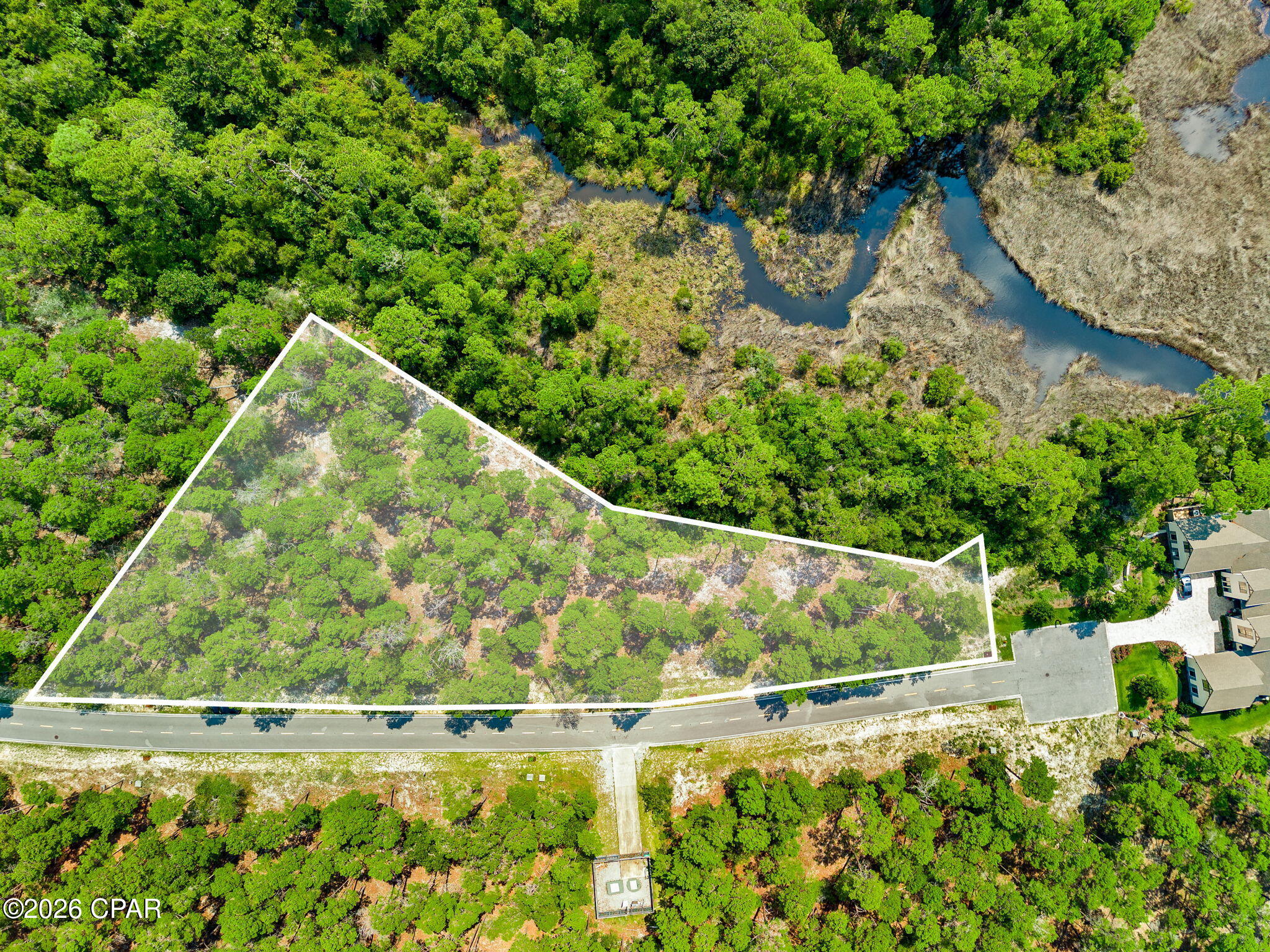 Build the home you've always envisioned on this exceptional 0.61-acre homesite in the exclusive gated community of Wild Heron. Surrounded by mature pines and bordering a tranquil preserve and winding wetlands, this property offers an extraordinary combination of privacy, natural beauty, and design potential. Selected by the current owner, a custom builder, for its unique topography, this homesite allows for one of the largest buildable footprints in Wild Heron and offers the opportunity for potential Lake Powell views from a second-story design. Located just minutes from Sharks Tooth Golf Club and Lake Powell, the largest coastal dune lake in Florida, you'll enjoy an unmatched lifestyle with resort-style amenities including a lakeside pool, fitness center, scenic walking and biking trails, community dock, playground, and parks. Just a short drive from the sugar-white beaches of the Gulf, Scenic Highway 30A, and Pier Park, this homesite offers the perfect balance of seclusion and convenience. Create a custom home tailored to your vision in one of Northwest Florida's premier gated communities, where nature, recreation, and coastal living come together.