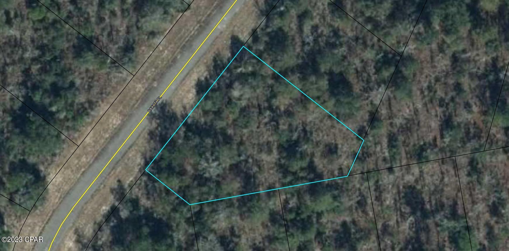 PRICE REDUCED !!! Ever think about making Florida your home or Looking for a sound investment in a thriving community? This is it ! Very nice large, wooded lot in a cul de sac. The lot has a slight slope to the back giving you great views of a large, wooded parcel behind it. The lot has a platted walkway beside the large lot in the cul de sac. This area has a community center and a golf course also has several lakes for swimming and fishing. All this located close to Hwy 77 for less than an hour drive to Panama City and the Beaches.