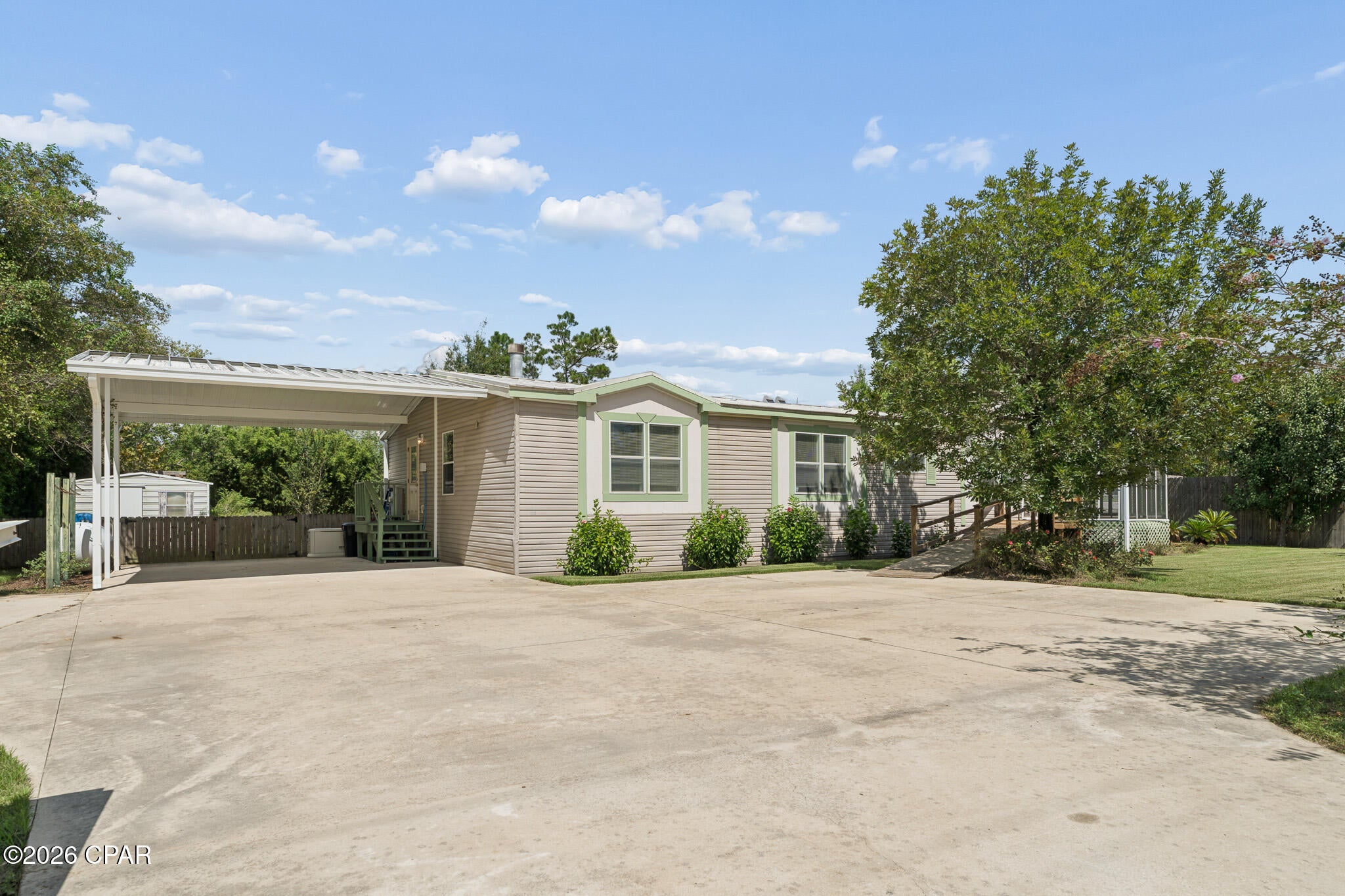 Enjoy space, functionality, and the Deer Point lifestyle with this mobile home situated on approximately ½ acre along a paved road. The inviting interior features a wood-burning fireplace, abundant kitchen cabinetry, and a spacious primary bedroom with an additional sitting area/flex space that could serve as an office, hobby area, or reading nook. The separate laundry room includes a washer and dryer along with a convenient half bath. The home is also equipped with a Generac generator for added peace of mind.
Outdoor living is a highlight with a screened front porch and a large screened back porch offering plenty of room to relax and enjoy the fresh air. The landscaped yard features beautiful crape myrtles lining the front, a fenced backyard, sprinkler system, French drain, and a water filtration system for the well. A ramp extends across the backyard providing accessible access to both storage sheds. Oversized concrete parking offers room for multiple vehicles along with a covered carport area.
Located in the popular Deer Point area, outdoor enthusiasts will appreciate convenient access to several nearby boat ramps, with opportunities for freshwater fishing and boating on Deer Point Lake as well as access to the waters of North Bay on the other side of the dam.
Survey available in the Documents tab. If measurements are deemed important, please verify.