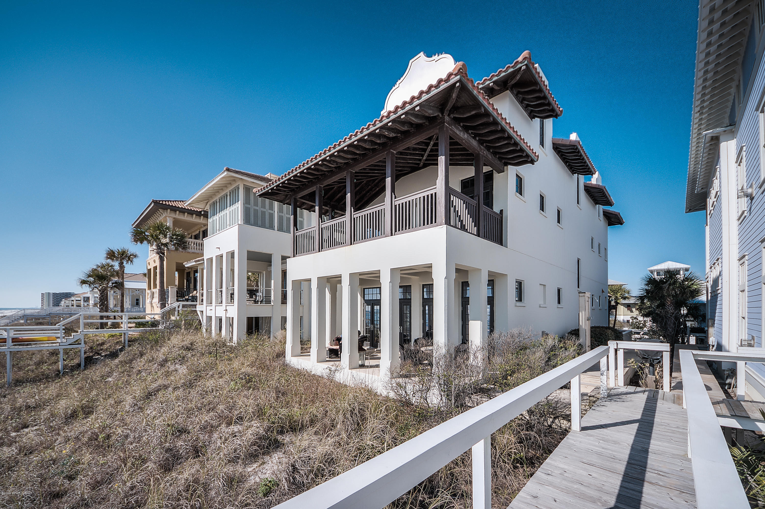 This fabulous Gulf front home, known as ''Seaduction'', was designed by renowned architect Gary Justiss and is truly stunning! Seaduction is a one of kind retreat in beautiful Carillon Beach with 4 bedrooms in the main house and an additional bedroom with luxurious living quarters in the guest house. Offering timeless design and construction with pecky cypress beams, hand wrought iron railings, stone flooring, spacious master suite, and breathtaking views of the sugar white sands and emerald green waters of the Gulf of Mexico. This home was designed as a place for many to gather together, while offering a peaceful retreat where everyone can find their own space to relax and unwind on island time.The first floor of the main house offers a completely open concept with sight lines out to the beach as soon as you enter. Here, you will find a beautiful and functional kitchen with Thermador, Wolf and Subzero appliances, as well as an elegant dining area, spacious living room with gas fireplace, and gulf front patio. You will also find a large wet bar and charming half bath tucked behind a beautifully detailed wood wall in the dining room.
The large master suite is located on the 2nd level, and offers its own private and spacious gulf front balcony, beautiful en suite bathroom, coffee bar, walk in closet and elegant pecky cypress beams sweeping throughout. You will also find a guest bedroom with its own full bath and one of three laundry rooms on this level. 
The third level of Seaduction offers 2 additional bedrooms, each with a private balcony, and a dedicated full guest bathroom. The stunning feature of the 3rd level is a very spacious multi functional room with breathtaking views of the gulf.
Seaduction's guest house was no afterthought, as the exquisite design and attention to detail makes these additional living quarters fully functional on their own. Large living room with fully equipped kitchen, full bath and additional bunks built into the wall are located on the main level of the guest house, while the downstairs includes a very spacious bedroom, full bath and fabulous sleeper porch. 
Additional features include elevator from ground to main and 2nd floor, 2 attached garage style golf cart bays, outdoor shower, large outdoor storage area, and fully integrated audio, video and security system. Seaduction is turn key and has never been used as a rental. Tastefully furnished and decorated by Sally Logan Interiors and Mayo Design center in Atlanta. With no detail overlooked this is truly a stunning place to call home.
Enjoy everything Carillon Beach community has to offer, such as tennis and basketball courts, 3 community pools, children's park, village green and the downtown Carillon area with live music, shops and eateries. Or relax and enjoy the serenity of kayaking or fishing in Lake Carillon, the secluded 13 acre lake inside the gates. Carillon is a pedestrian and golf cart friendly community, allowing you to park the car and leave it while you enjoy everything it has to offer.
