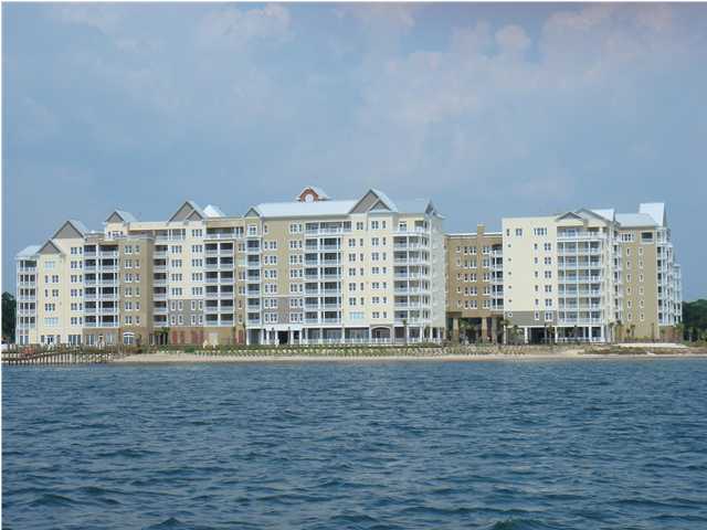 Rare Opportunity! Furnished 3 bedroom, end unit with extra windows overlooking Oaks by the Bay Park.  Beautiful South view of St Andrews Bay.  New flooring, fresh paint, new air conditioner, etc make this spacious condo a wise decision for the one searching for all these features.  Walk to dinner in sweet St Andrews.  Park in the garage.  Enjoy the green landscape and out door fireplace on top of the garage. Take a refreshing dip in the bay side swimming pool or work out in a fitness center with floor to ceiling windows overlooking the bay.  No better place in Bay County!