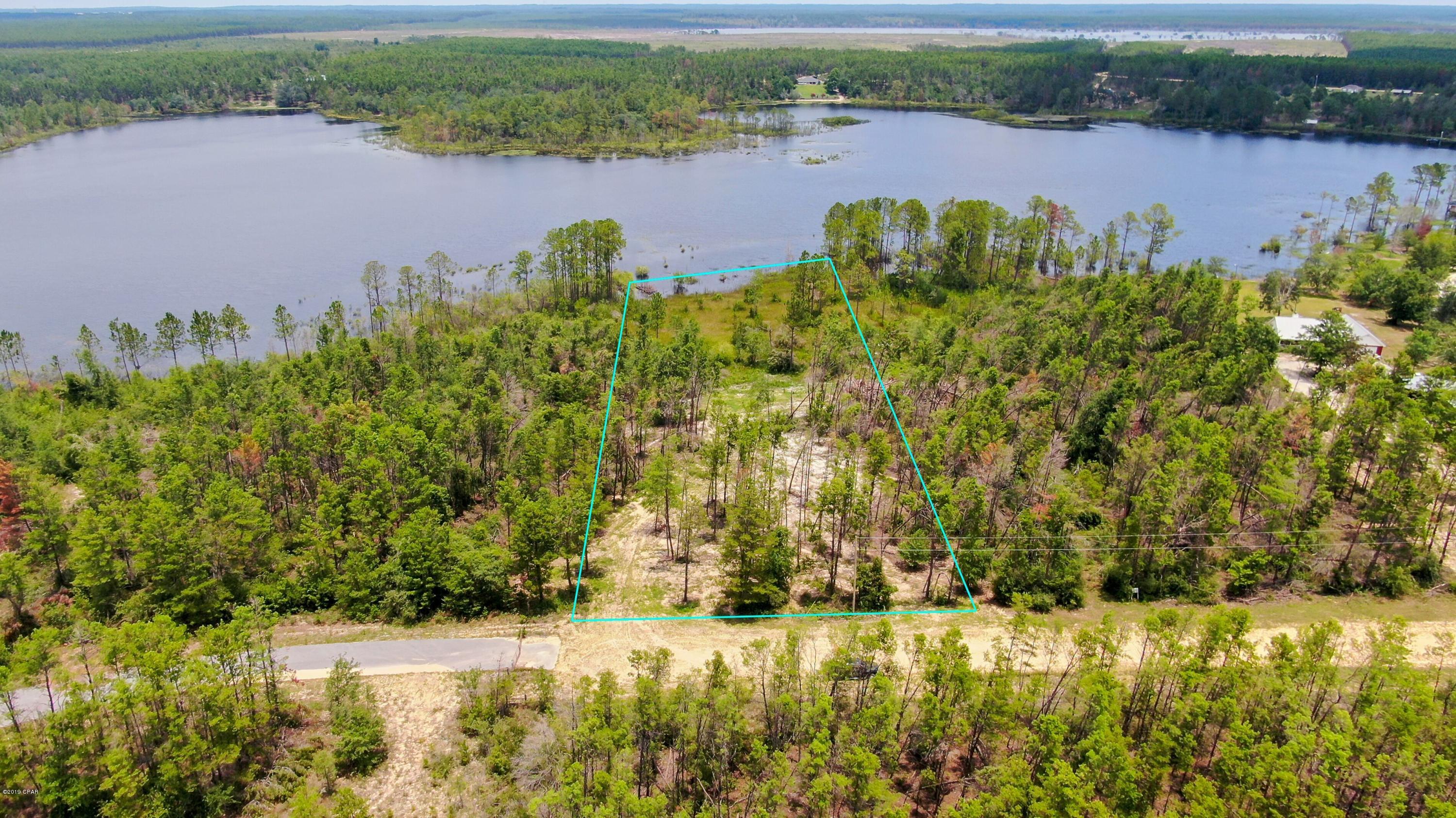 Own your piece of waterfront heaven.  Build on this sprawling property in Chipley, situated on Long Lake...... HOA fees are under $100 a year, no mobile homes- just a quiet, serene, beautiful country setting to build your dream home on the lake without paying exorbitant Post-Hurricane Michael prices. Lot is not fully wooded. It has been cleared enough to accommodate a minimum of a 1200 square foot home. It is indeed a ''Boat Lake'', allowing boats with motors. The fishing at this lake is outstanding, and only open to those that live in the community! Make an appointment to see this slice of paradise today. Sizes and measurements are approximate- please measure if important.