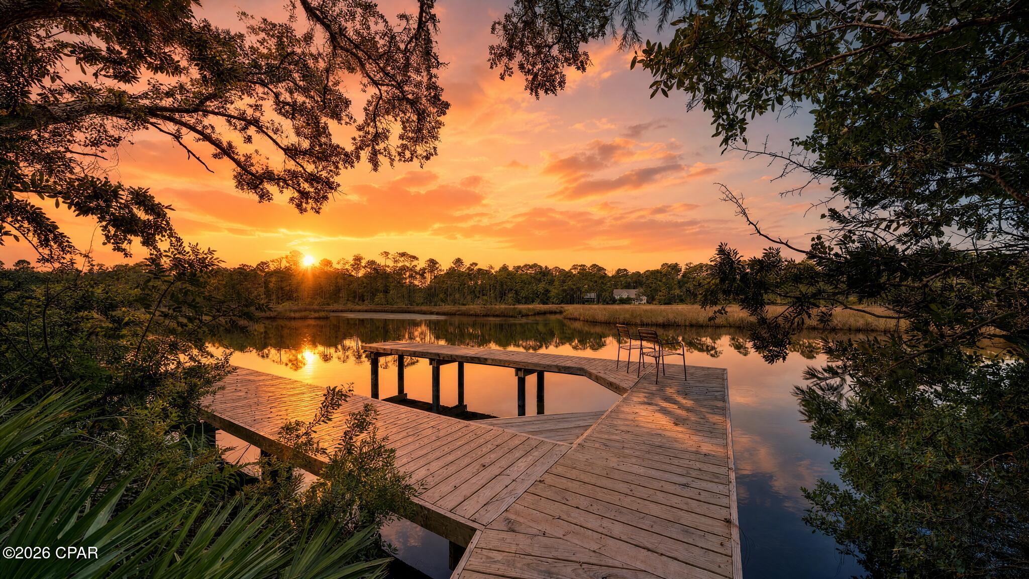Wake up to the sound of calm waters and birdsong on this breathtaking bayou-front property, with direct access to Choctawhatchee Bay right outside your back door. Tucked away on a lushly wooded .70-acre lot, this is the kind of rare, unspoiled waterfront setting that's nearly impossible to find in Santa Rosa Beach -- mature trees, total privacy, and stunning water views in every direction. Never-lived-in and built in 2025, this gorgeous 5-bedroom, 3-bath home delivers 3,129 square feet of coastal craftsmanship, complete with a boat dock, covered porch, 2-car garage, and designer finishes throughout. Launch from your backyard, fish from your own dock, or simply sit and watch the bayou come alive, (even dolphins have been spotted)-- this is peaceful, private waterfront living at its absolute finest. Just minutes from 30A beaches. From the moment you arrive, you'll be captivated by the home's inviting presence, new construction quality, and thoughtfully designed layout that blends comfort, function, and modern coastal style. Step inside to a light-filled open-concept floor plan featuring a welcoming foyer, a formal dining room, and a dedicated breakfast room perfect for both everyday living and entertaining. The expansive living area flows seamlessly into a chef-inspired kitchen with brand-new appliances, modern cabinetry, and premium finishes.
A versatile bonus flex space offers the perfect opportunity for a home office, study, or media room, providing flexibility for today's lifestyle needs.
The spacious primary suite offers a private retreat with spa-like features, while four additional bedrooms provide ample space for family, guests, or multi-generational living--all finished with clean, modern design and high-quality craftsmanship throughout.
Enjoy true Florida waterfront living with both a large covered front porch and an expansive covered back porch, ideal for relaxing, entertaining, and enjoying peaceful water views and coastal breezes. The backyard flows naturally toward your private boat dock with direct access to the bay, making boating, fishing, paddleboarding, and sunset cruises effortless.
Set on almost an expansive private lot, this property offers exceptional room for a future pool, outdoor kitchen, or custom outdoor oasis.
