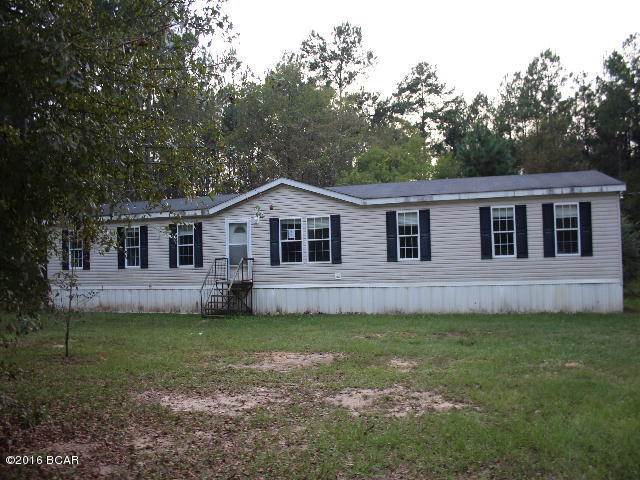 This is a large doublewide mobile home with updates and repairs needed but will make a great investment property! It has 4 bedrooms and 2 baths. The master bedroom has a private sitting room and a very large master bath. There is a den with a fireplace. All of this is situated in 1.3 wooded acres. Location is very convenient to town and local amenitiesa.