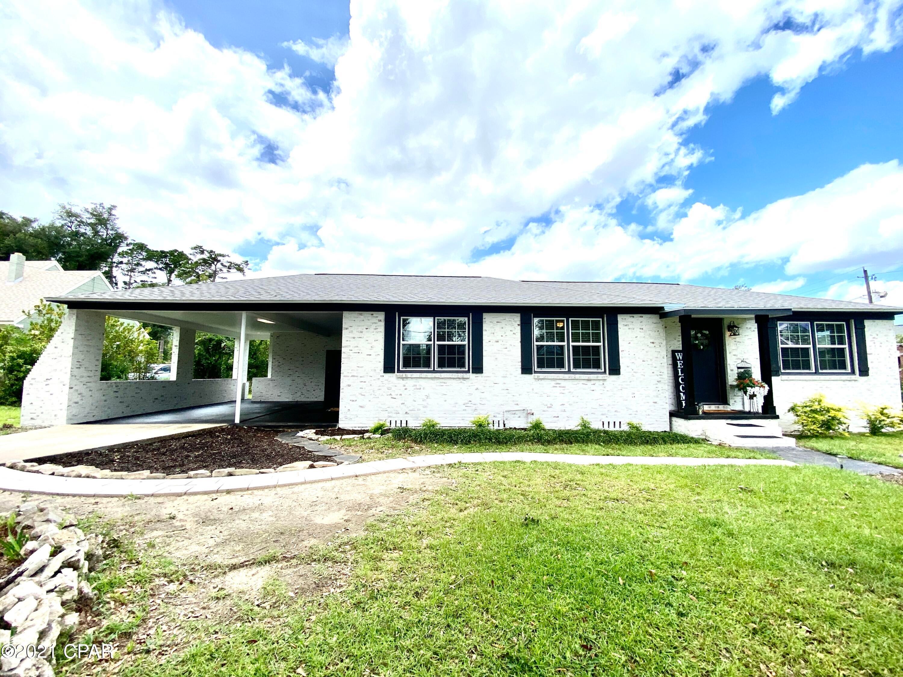 GERMAN SMEAR EXTERIOR! Move-in ready 3 BR/1 bath brick home on corner lot w/ carport & sunroom in the heart of Marianna .8 mile from Chipola College. This home has new wiring, a 2019 roof, 2018 HVAC, 2017 hot water heater. The interior features a neutral color scheme, new vinyl tiles in kitchen, some new light fixtures, newer stainless steel appliances, & a washer & dryer which convey. Overhanging limbs have been cut back, & a German Smear finish has been applied to brick, which makes the home stand out with character in this well-established neighborhood! The exterior trim, doors, & shutters have been painted Wrought Iron, carport & porches stained, & 6x6 stained wood columns added to the front porch, all bringing a modern flair to this vintage home!