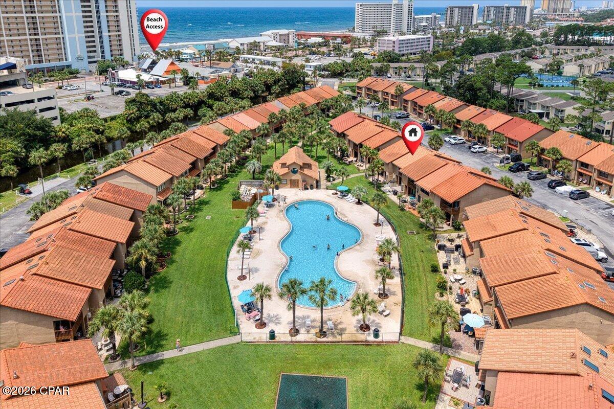 5-minute walk to the beach! Welcome to Gulf Highlands Beach Resort, where this 2-story, 2-bedroom, 2.5-bath townhome is being SOLD FULLY FURNISHED and is ready for immediate enjoyment or to become your next investment property! With rental projections of approximately $38,000 annually, plus a 2022 roof and 2022 HVAC, this property is ready to go. Inside, you'll find a bright, neutral interior with an open layout. The kitchen features tile flooring, stainless steel appliances, abundant cabinetry, and a large breakfast bar with ample seating, while the adjacent dining area accommodates more seating. The spacious living room opens through sliding glass doors and is one of the few units with a covered patio overlooking one of the community pools. There's also a shared green space, creating a relaxing outdoor setting. Additional conveniences include two owner's closets for secure storage and two assigned parking spaces. Both bedrooms and the laundry room are located upstairs. The spacious primary suite features a vaulted ceiling, private balcony with pool views, and an ensuite bathroom with a tub/shower combination. The second bedroom also includes its own ensuite bathroom with a walk-in shower, offering privacy for guests. Gulf Highlands Beach Resort is packed with amenities, including private beach access, 11 swimming pools with one being Gulf front, newly added pickleball courts, basketball courts, shuffleboard courts, mini golf, and a fitness center. Centrally located in Panama City Beach, you're just minutes from shopping, dining, and local attractions. Whether you're looking for a beach getaway, full-time residence, or short-term rental investment, this townhome offers an excellent location, strong income potential, and outstanding resort-style amenities!