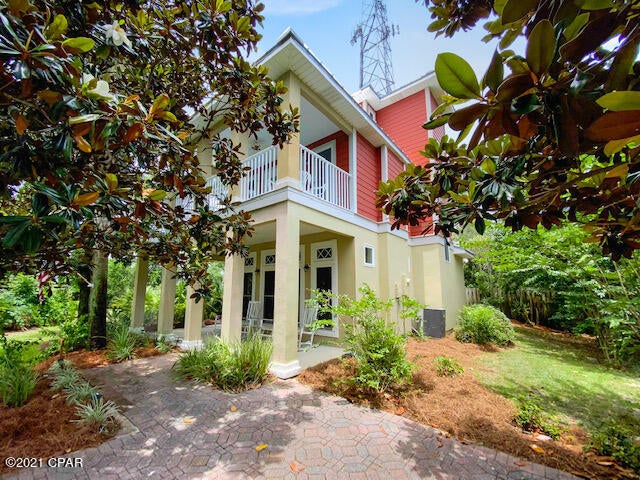 This 3 story, 3 bedroom, 3 bath home is immaculate. This home is less than 1/2 mile to the beautiful beaches and 1 mile to Pier Park. Also, this is a golf cart friendly community making it very quick and easy to get to the water or Pier Park. As you walk in the home you'll immediately notice the beautiful hard wood floors, solid surface countertops, slate backsplash, and stainless steel appliances. The first floor has a bedroom, full bath and laundry room.  On the second floor you have your master bedroom, and 3rd bedroom, each with their own private balcony. The 3rd floor could be used as a 4th bedroom/bunk room and features great views, a wet bar, and a huge balcony!. This home has almost 900 Sq.Ft. of outdoor porches and balconies for you outdoor enjoyment. **Most furnishings included**