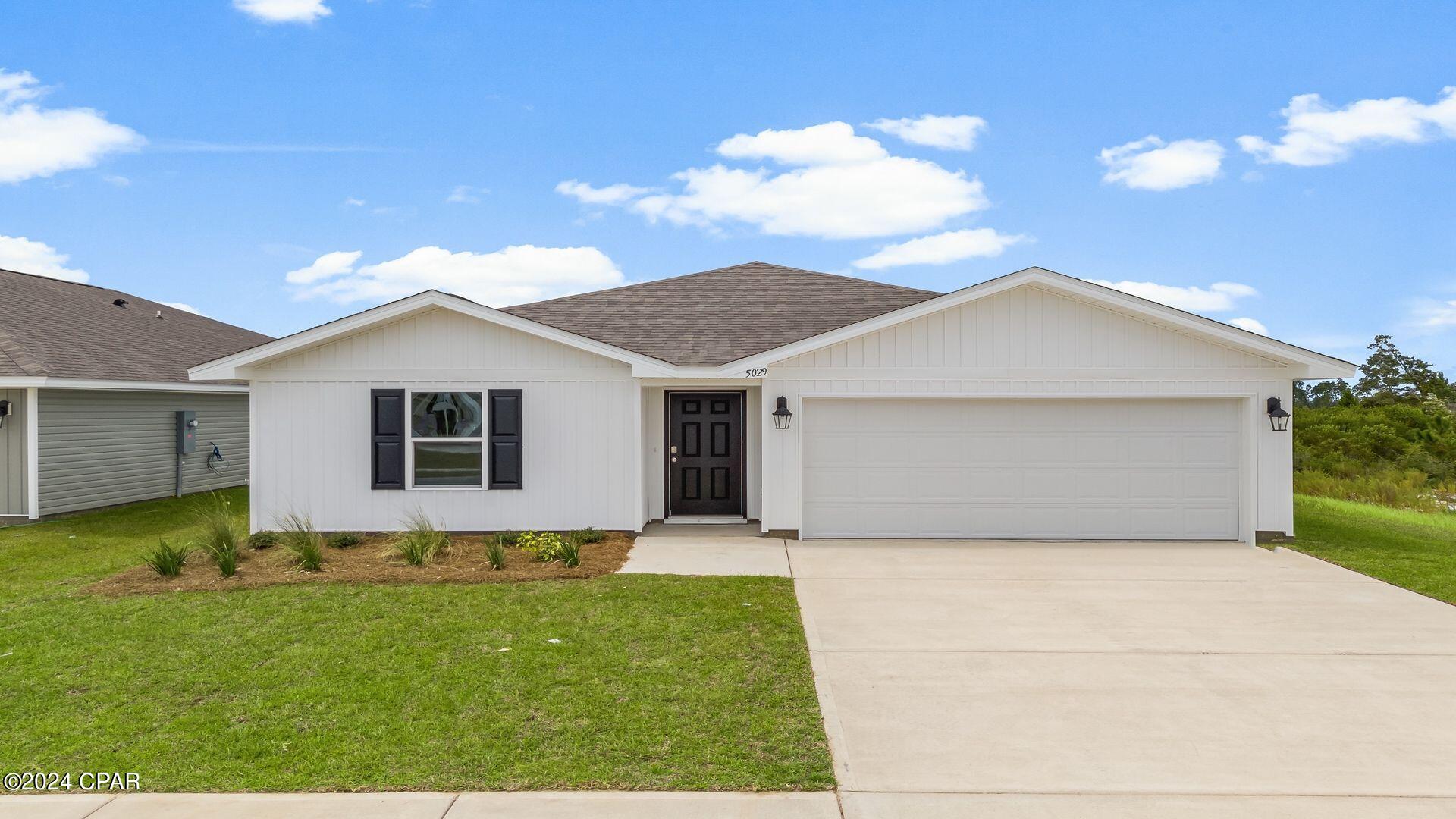 New construction home located in Titus Park at 5029 Windrow Way. This home is the Freeport floor plan and is a single story, 4-bedroom, 2-bathroom home with approximately 1,458 SF.

As you walk along the sidewalks that lead to this home, you will see a fully sodded lawn as well as flower beds that adorn the front entry. 

Inside you will see 8' ceilings throughout, engineered vinyl plank flooring throughout the home and carpet in the bedrooms. Granite countertops, white cabinetry and a spacious open living room and kitchen make this home perfect for having guests over. The kitchen has a center island that is perfect for serving kids or guests, a nice size pantry and the stainless-steel appliances include smooth top range, microwave, and dishwasher. Located right next to the dining area, this makes serving meals with ease.

The primary bedroom has a spacious bathroom and features a double vanity with granite countertops. A walk-in closet with ventilated shelving is also located in the bathroom, giving you more room in the primary bedroom. The guest bathroom features a single vanity with granite countertops and a shower.
Titus Park Titus Park is a new home community in lovely Panama City, Florida. Each home has a landscaped yard with fresh sod as well as a flowerbed just off the front entry.  Located right off Highway 231, it is conveniently located close to shopping, food, great schools, and not far from Tyndall Air Force Base. A new Publix shopping center is located just outside of the community.