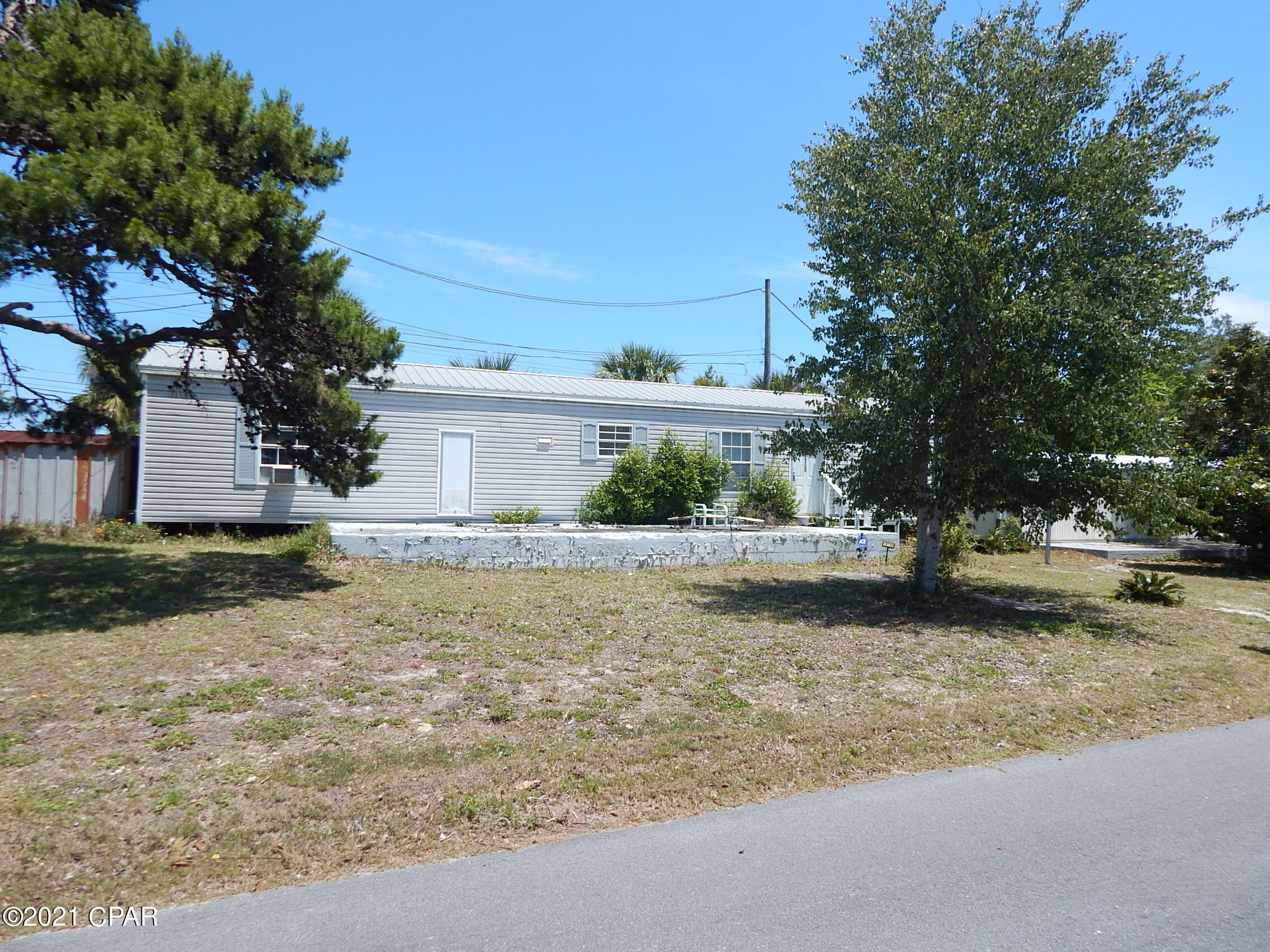 FOUR BLOCKS FROM THE BEACH!!!  This property is on a corner lot with 2 bedrooms and 2 bath in the desirable Laguna Beach Estates.  Mobile home is 1994 with a metal roof.  Zoned R-2 for a duplex or beach cottage, or short term vacation rental.  Property is sold ''As Is'' and needs minor work.  It does come with a washer/drier and just about move in ready with minor work needed.