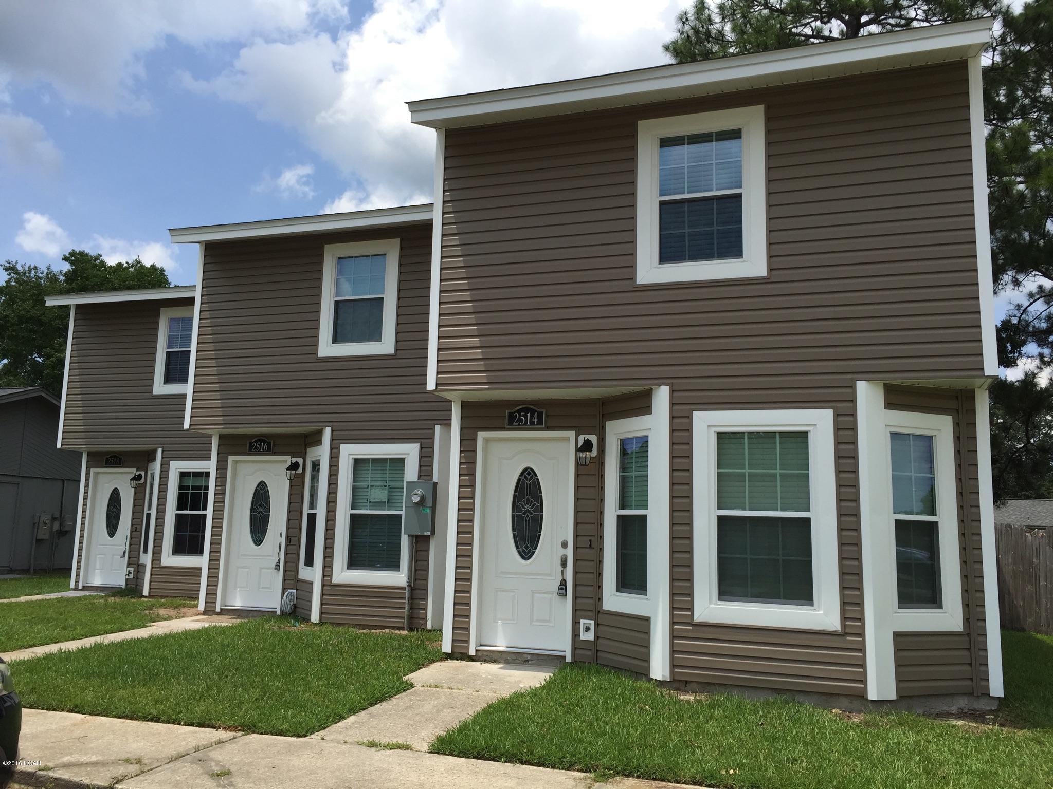This gorgeous 2 bedroom 1.5 bath townhome is move in ready! There are 2 bedrooms and a full bathroom (ceramic tile) upstairs. Main level features ceramic tile, a living room, dining area, 1/2 bath, and laundry. The kitchen features custom cabinets, granite counter tops, and black appliances. There is a screened in patio overlooking the backyard. 2 parking spaces in front of the unit. Located in Lynn Haven!!! Lawn maintenance included.