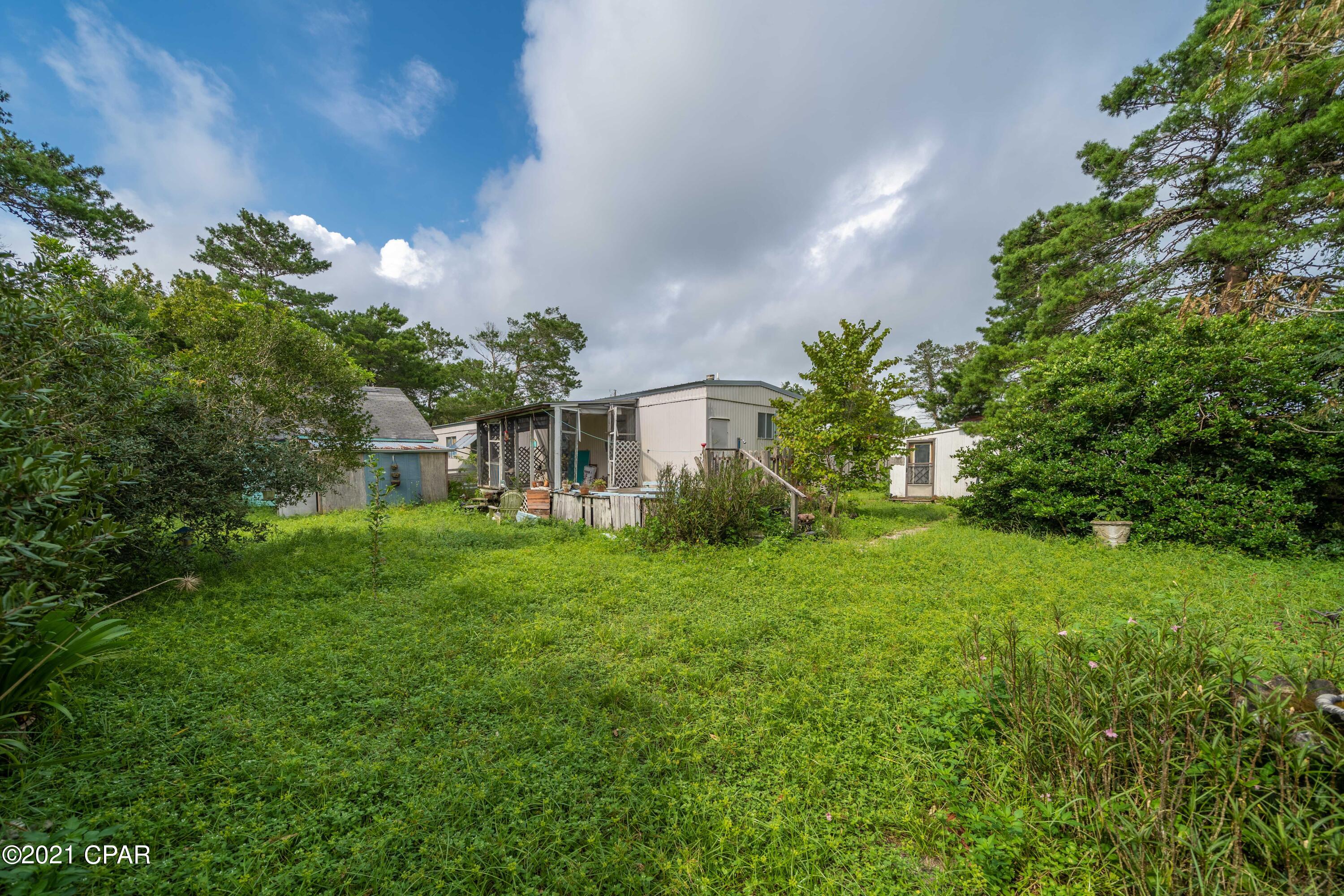 A cash investor needed ! This three bedroom 2 bath single wide trailer is located on the west end of the beach and just blocks from the gulf. This property is a large 85' X 148' lot. There is a new roof 2019 New water heater 2020, new power pole 2021

There is a barn with a bedroom and a small kitchen with a loft. There is also a nice shed in the back yard. Your only limitation is you imagination.