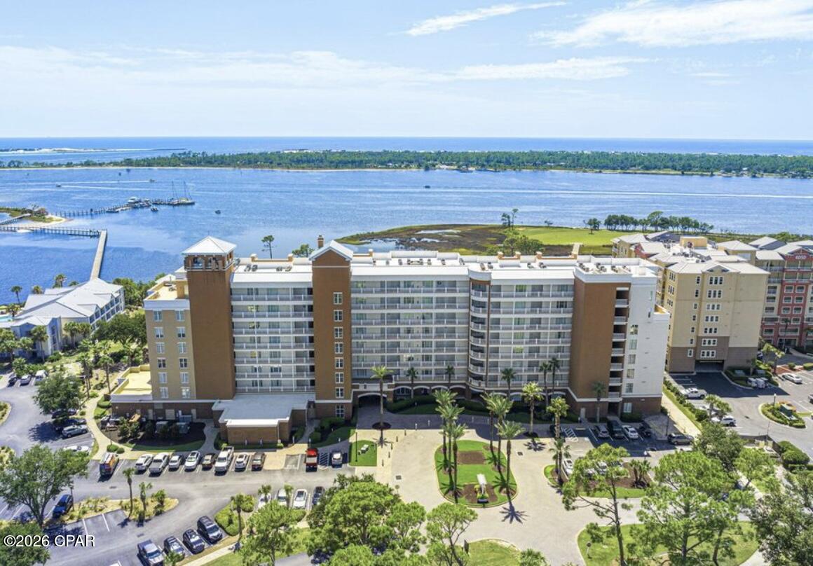 Wake up each morning to breathtaking views of Grand Lagoon from your private Balcony in this beautifully furnished one-bedroom, one bath condominium at the highly desirable Reflections at Bay Point Resort. This beautifully appointed residence features an open concept floor plan with granite countertops, stainless steel appliances. a breakfast bar, crown molding, tile flooring, and a luxurious oversized walk in tiled shower with glass doors. The spacious primary suite and elegant finishes create the perfect setting for a primary residence, vacation getaway or investment opportunity. Enjoy the exceptional amenities that make Reflections on of Bay Points premier destinations including a zero entry pool Serenity spa and marina access and gated community with security.