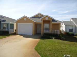 This is a beautiful 3 Bedroom 2 Bath home in immaculate condition one block from the beach, on a quiet side street -- utilized as a second home and never on the rental market! Upgrades include: ceramic tile in the entry foyer, kitchen and both bathrooms. Kitchen area is roomy with a pantry and breakfast bar. A separate dining area is adjacent to the spacious living/family room. The oversized master bedroom adjoins the large master bathroom with dual vanities, walk-in closet and nice tub-shower combination. The two additional bedrooms are adjacent to the second full bathroom. The one-car garage has an automatic door opener and storage space. Sellers are providing Buyer(s) with a one-year home warranty. If you are looking for a low maintenance home, in excellent condition and