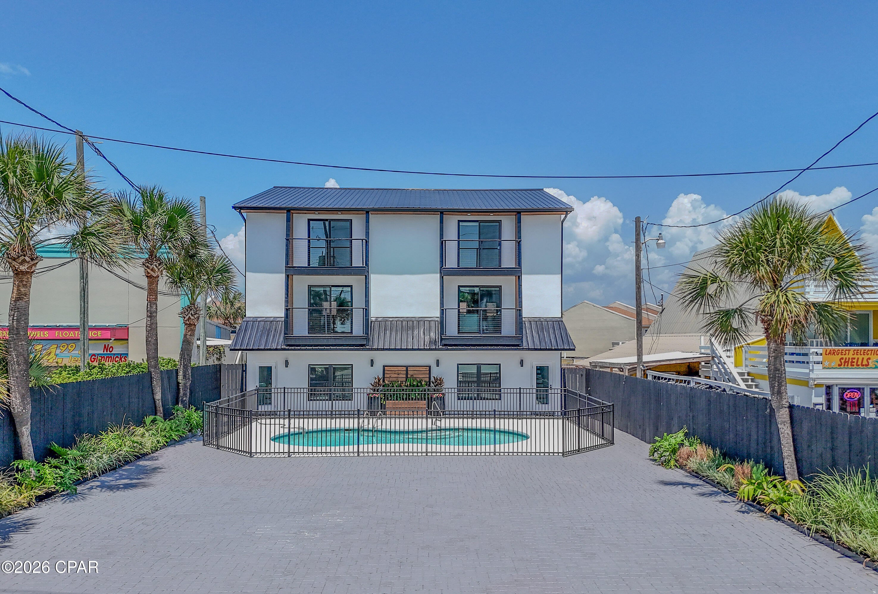 Completely reimagined and extensively renovated in 2026, this Miramar Beach duplex offers two identical three story residences totaling 5,040 square feet of heated and cooled living space. With no HOA, deeded beach access directly across Scenic Gulf Drive, Gulf views, a fenced shared pool, and an updated paved driveway with on site parking, this is a rare Emerald Coast opportunity. Each residence offers approximately 2,520 square feet with 4 bedrooms, 3 full bathrooms, and 1 half bathroom. The first floor includes two bedrooms, a full bathroom, and a spacious living area with direct pool access. One first floor bedroom in each residence features custom built bunk beds for additional sleeping accommodations. The second floor features an open living and dining area, half bathroom, Gulf view balcony, and updated kitchen with quartz countertops, white shaker cabinetry, subway tile backsplash, stainless steel appliances, and generous storage. The third floor provides two bedrooms, two full bathrooms, and an additional Gulf view balcony. Permitted improvements include a metal reroof, siding, doors, flooring, sheetrock, kitchens, bathrooms, water heaters, vanities, plumbing and electrical fixtures, trim, ceiling fans, lighting, paint, and refreshed exterior amenities. This property offers exceptional flexibility for investment, multigenerational living, or a coastal retreat.