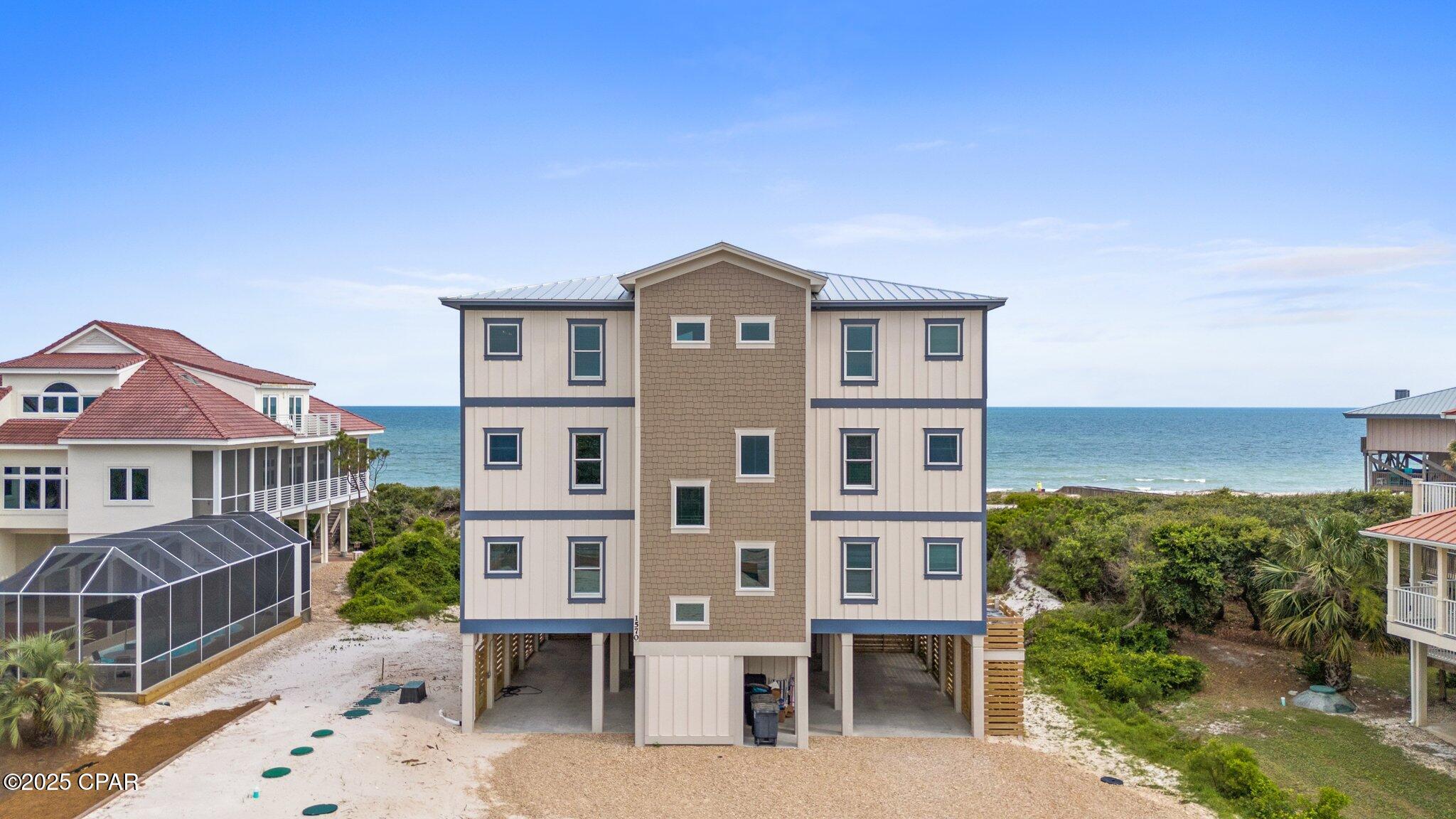 CURRENTLY UNDER CONTRACT, SELLER WILL CONSIDER BACKUP OFFERS.  BEACHFRONT ESTATE!!! This residence is the epitome of coastal luxury, perfectly crafted for large gatherings, family retreats & unforgettable celebrations. Spanning three levels with 10 bedrooms & 11 full baths, this home offers endless comfort & breathtaking Gulf-front views. Step inside to find an open-concept living area with soaring ceilings & walls of glass that drench the interior in natural light while framing postcard-perfect views of the Gulf of Mexico. The gourmet kitchen is a showpiece with stainless steel appliances, marble countertops & an island with bar seating--designed to make cooking & entertaining for a crowd effortless. The home was built for fun & connection, offering a second living room & game area complete with a pool table, arcade games & a wet bar. Guests can spread out across five beachfront-facing bedrooms, each with private access to wide decks where the sound of the surf provides a soothing backdrop day & night. An elevator services every floor, ensuring that accessibility & convenience match the home's elegant design. Step outside to discover a true private resort. The raised heated pool sparkles under the sun, while the hot tub invites relaxation after a day on the sand. The expansive decks provide countless places to gather for dining, cocktails or simply soaking in the view. A private boardwalk leads directly to the sugar-white sand, making it easy to move seamlessly between poolside lounging & Gulf-front fun. Located in the peaceful East End of St. George Island, this estate offers unmatched access to the island's natural beauty. Here, mornings are best spent sipping coffee as dolphins swim by, afternoons are filled with paddleboarding or boating adventures & evenings bring dazzling sunsets over the horizon. The island life is rich with experiences--golf cart rides along quiet streets, fishing the bay or surf, exploring the nearby state park, or dining on fresh local seafood. Call for your private tour & LIVE THE BEACH LIFE!