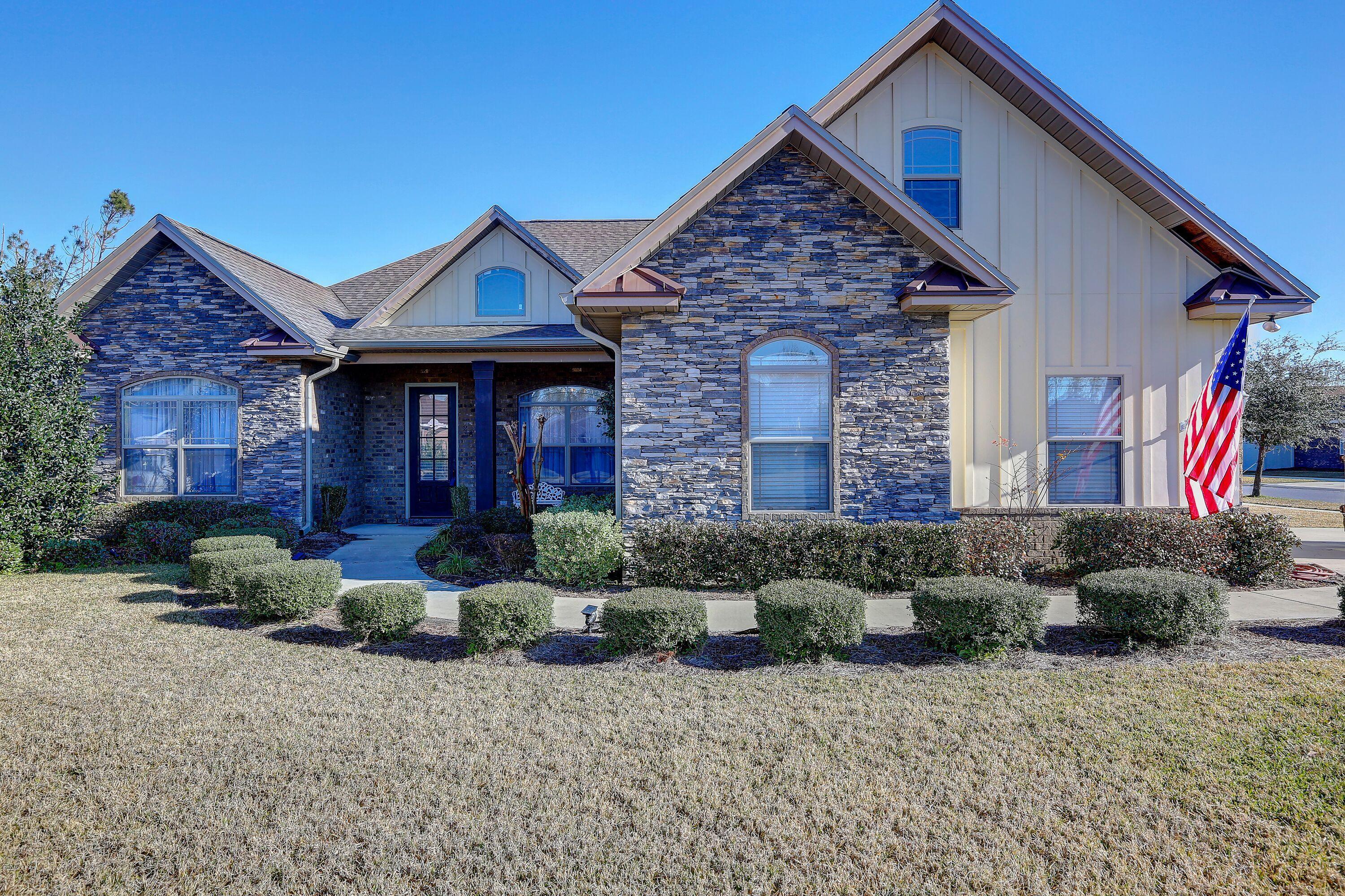 Fabulous custom home on corner lot in Hawks Landing.  This remarkable home features 4 bedrooms and 3 baths on the ground floor and 1  bedroom and 1 bath upstairs. The open floor plan allows great utilization of the space.  Ceilings are 9' and 10' high giving it even more of a spacious feel.  Beautiful hardwood floors in main living areas with new carpet in the bedrooms. The kitchen is a gourmet's delight featuring stainless appliances and custom cabinets.  This home features a split bedroom plan.  The home has a ''Smart Home'' feature.  There is a spacious screened-in porch the back of the house. This home suffered no storm damage, but does have a new roof. The house is wired for a generator and the generator will stay with the house. Washer and dryer do not convey