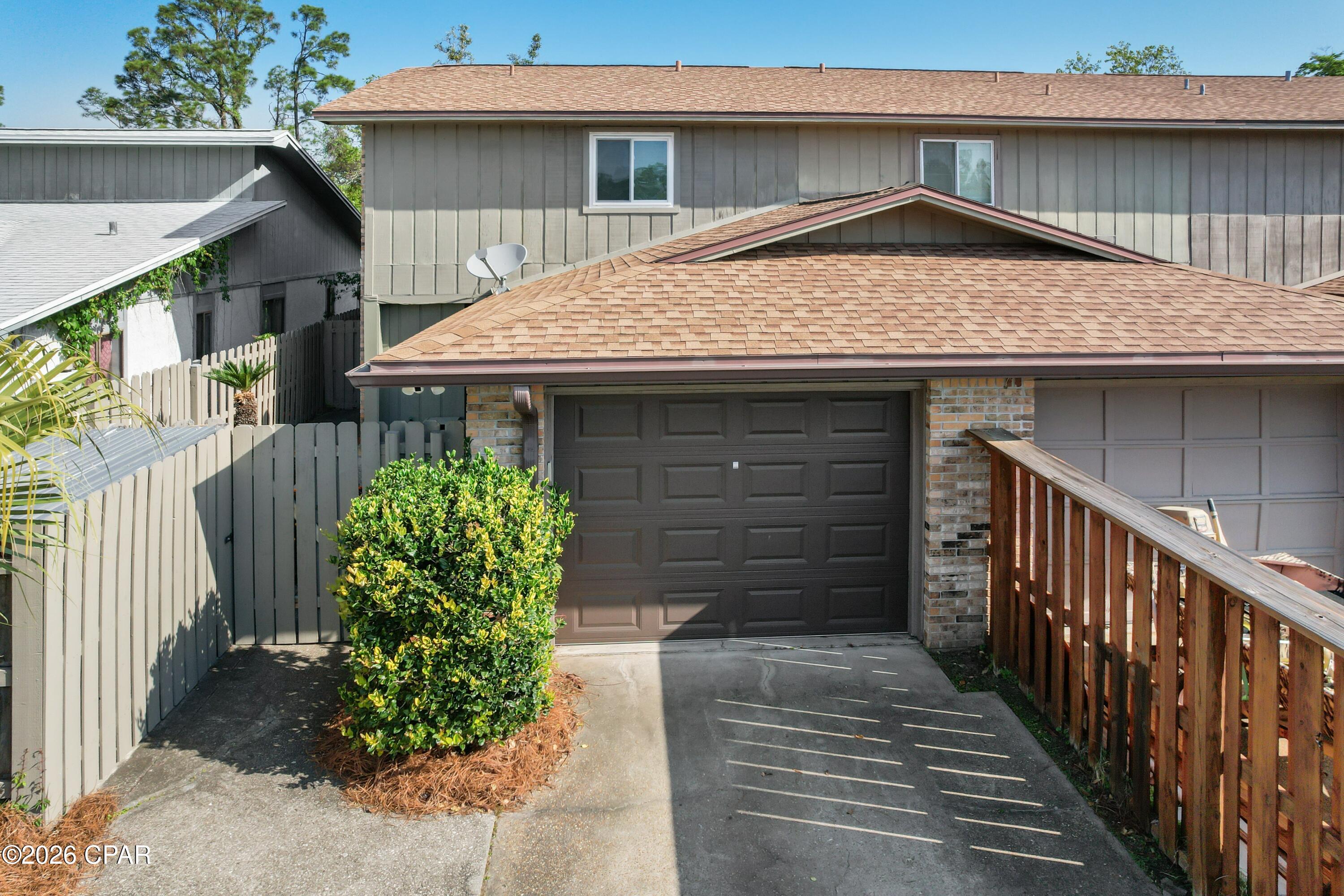 COZY END-UNIT TOWNHOME IN ST. ANDREWS. This 3-bedroom, 2.5-bath townhome offers over 1,400 sq. ft. of living space and features a semi-open floorplan with attractive LVP flooring, perfect for both everyday living and entertaining. The kitchen comes complete with stainless steel appliances, a breakfast bar, a pantry, and a convenient built-in desk area.  Ample natural light fills the home, highlighting the fresh interior paint and updated windows and doors. All three bedrooms provide a comfortable retreat with soft carpet underfoot, and both the master bath and the hall bath have been tastefully refreshed.  The 1/2 bath downstairs is great for guests! The exterior features a charming front courtyard that welcomes you home and leads to an XL fenced backyard, a rare find for most townhomes. The back also includes an open patio that is nice for grilling or quiet evenings.  Don't forget to walk the property line down to the pond.  Additional features include a one-car garage with pull down attic stairs and an enclosed storage area that keeps garbage cans and lawn equipment neatly tucked away and out of sight.  Centrally located near shopping, dining, and schools, this home offers the perfect blend of comfort, functionality, and convenience.  Call today for a private preview. Measurements approximate.