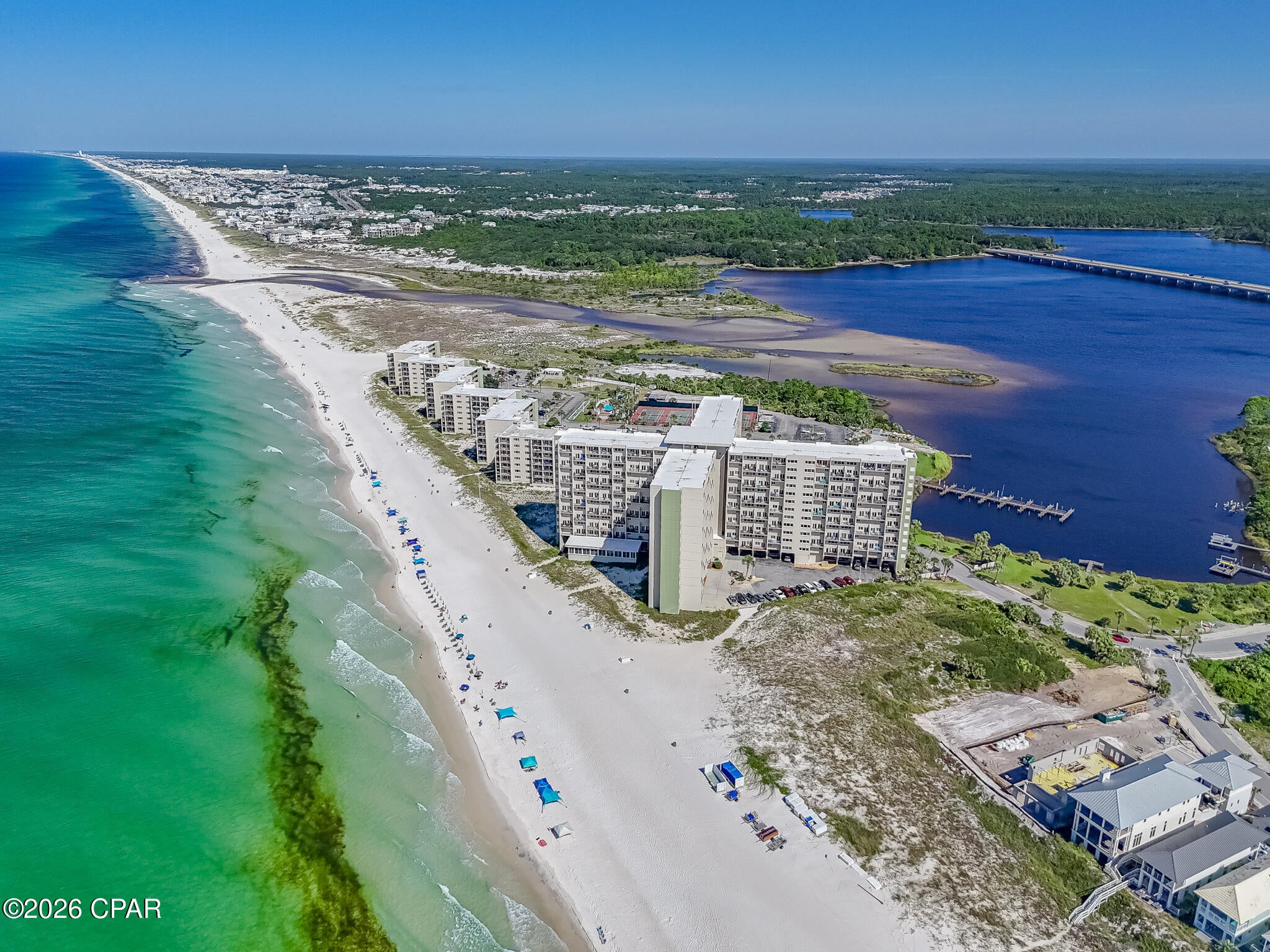 Enjoy the best of coastal living from this Gulf-front condo in Pinnacle Port, where beautiful water views and resort-style amenities create the perfect Panama City Beach getaway. The two-level layout offers a comfortable separation between the main living space and bedrooms, while luxury vinyl plank and tile flooring make beach living easy. Relax on the private balcony and take in views of the Gulf and nearby lake, or spend the day enjoying everything the community has to offer. Pinnacle Port features direct beach access, community pools, hot tub, fitness center, tennis courts, fishing, boat facilities, dock, game room, barbecue areas, and more, all within a gated community with 24-hour security. Short-term vacation rentals are allowed, offering the opportunity to enjoy the condo as your own beach retreat while also generating rental income when you're away. Located on the quieter west end of Panama City Beach near Carillon Beach, this condo is an excellent option for a vacation home, income-producing rental, or a combination of both.