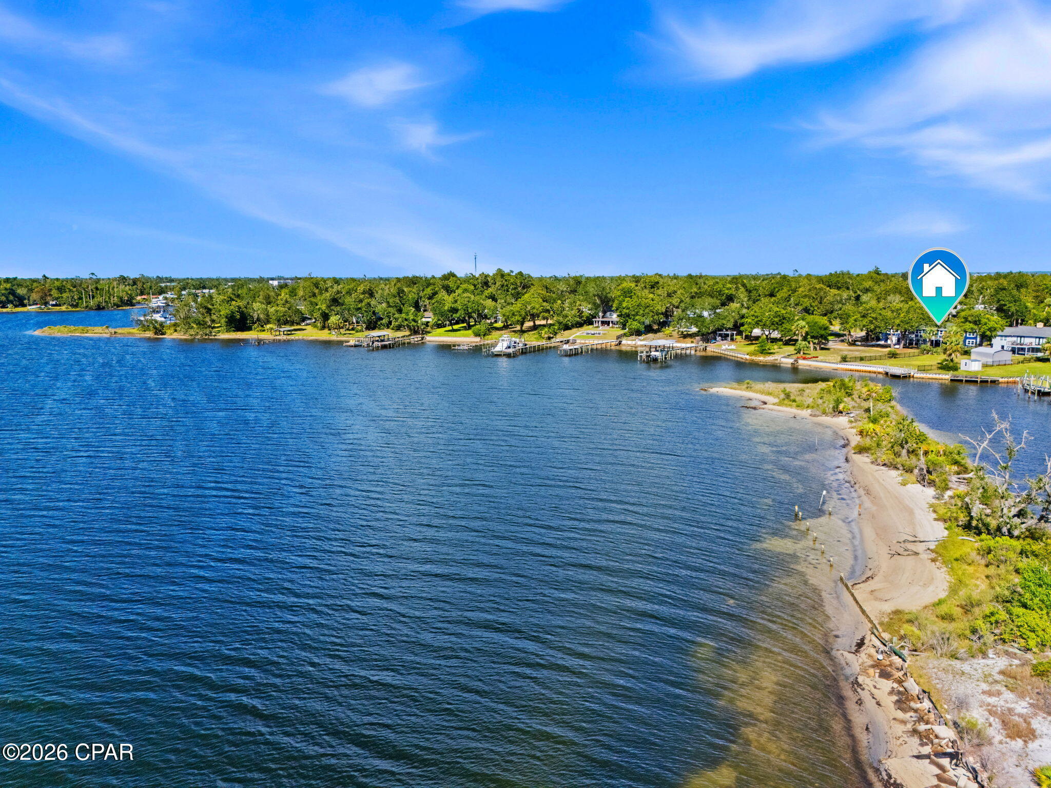 CURRENTLY UNDER CONTRACT, SELLER WILL CONSIDER BACKUP OFFERS' Stunning Deep-Water Retreat --> Fully Reimagined with Gulf Access
Tucked onto approx. 65' of water frontage with direct deep-water bay and Gulf access, 1440 Dover Road is a rare blend of craftsmanship, flexibility, and waterfront living. Originally built in 1950, this two-story home has been extensively remodeled and thoughtfully updated throughout; floorplan restructured, new electrical and plumbing, tankless water heater, whole-house filtration system, windows, and Hardie board siding, just to name a few. The home features durable concrete block exterior construction with a stick-built interior. In the main-level showers and floors, you'll even find premium epoxy grout (waterproof, stain-resistant, and mildew-proof). The roof and seawall have also been replaced.
Spanning 3,602 square feet, the home offers 4 bedrooms and 3.5 baths across two distinct living levels. The main level features a remodeled kitchen with granite countertops, stainless appliances, under-cabinet lighting, an open living and dining area, and a generous primary layout. Original red oak hardwood floors, refinished in a soft gray tint, bring timeless character with a fresh, modern feel throughout. The main level opens to a deck with a breathtaking view of the bay.
The lower level lives like its own private retreat: a second full kitchen with butcher block countertops, family room, a fourth bedroom, additional laundry room, full bath, and its own one-car garage. It can be reached by the interior staircase or, completely independently, from its own private entrance at the back of the property ->with a dedicated driveway and garage. This level offers convenient single-level, step-free living -> no stairs throughout (just a small lip at the entry) and a zero-entry shower, making it ideal for multi-generational living, guests, or a private in-law or guest suite. There are also two attached one-car garages on the main level.
Set on just over half an acre (0.57) in an established, water-oriented neighborhood, and located in Flood Zone X (outside the special flood hazard area), a meaningful advantage for waterfront buyers. Convenient to schools, shopping, Tyndall AFB, and only 15 miles from the Naval station.
With a newer seawall and stairs leading right into the water, this property puts deep-water living within easy reach. Homes with this combination of quality, space, and true deep-water access don't come along often. This home is waiting for your dreams and memories to be made here.