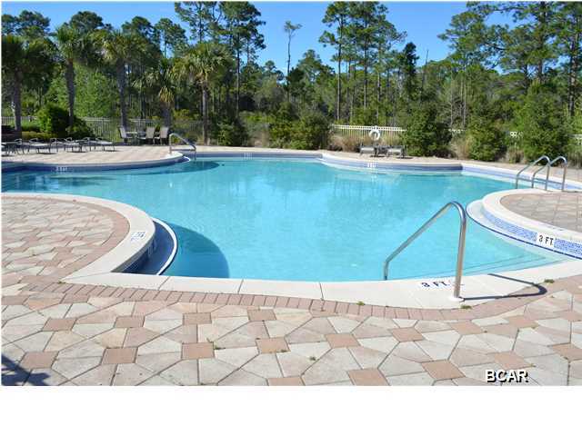 Vacant lot located in Paradise Grove Subdivision. Paradise Grove boasts cottage style homes that are nestled in a gated community that is surrounded by lush beach style landscaping. Paradise Grove is a new gated community that is located west of Highway 79, on the north side of Highway 98, and in the Laguna Beach area just four blocks from the Gulf of Mexico. It is also located near, Panama City Beachs Pier Park and Frank Brown Park. So whether you are into the beach, shopping or sports, there is something for everyone to do! Its easy access from Highway 79 and the new Northwest Florida Beaches International Airport makes Paradise Grove ideally situated. There is a large resort style pool surrounded by custom pavers and a large lounge area. Build your dream beach getaway today! There is